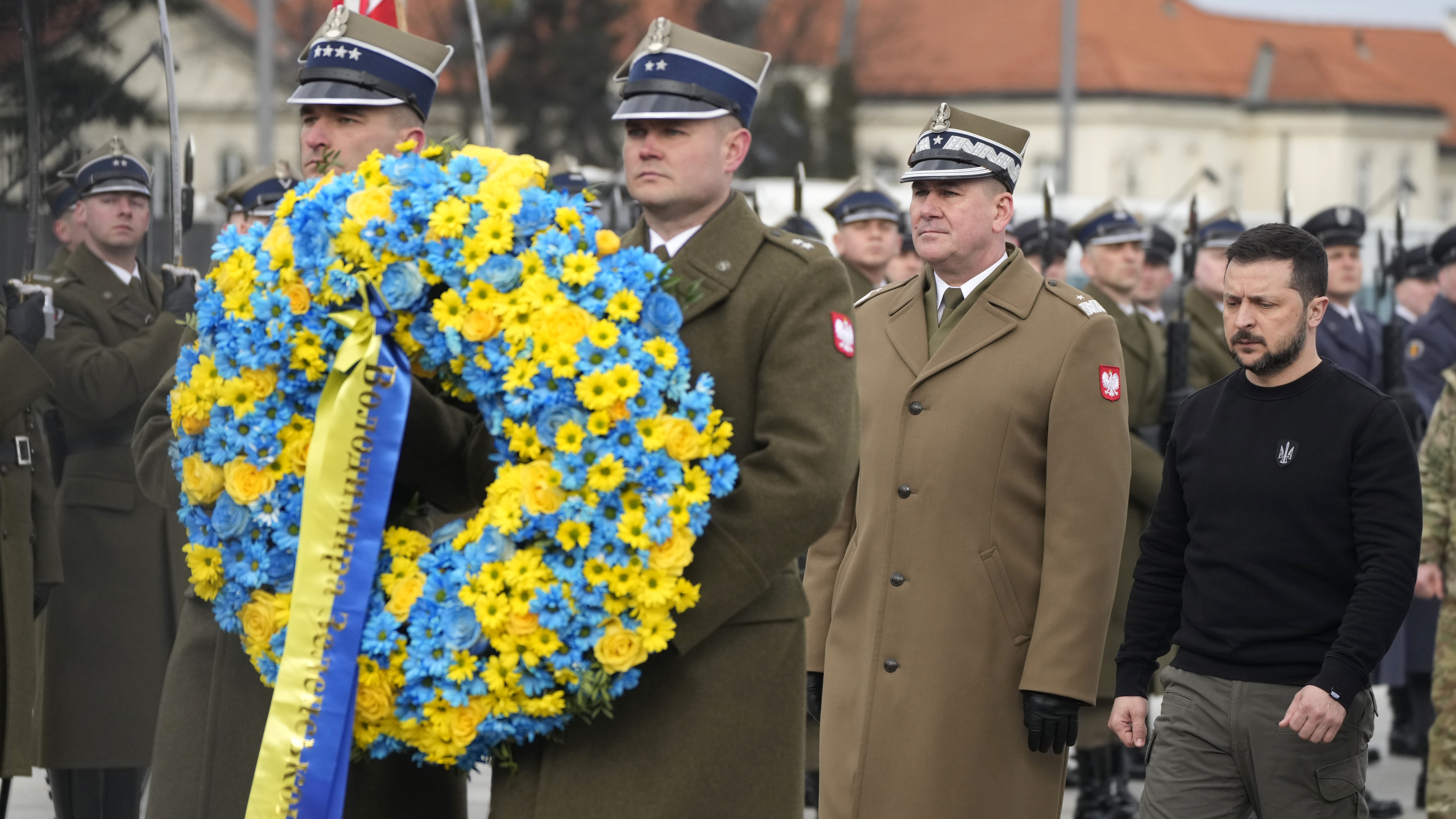 Ukrainian President Volodymyr Zelenskyy lays a wreath of flowers at the Tomb of the Unknown Soldier during his visit to Warsaw, Poland, Wednesday, April 5, 2023. (AP Photo/Czarek Sokolowski)