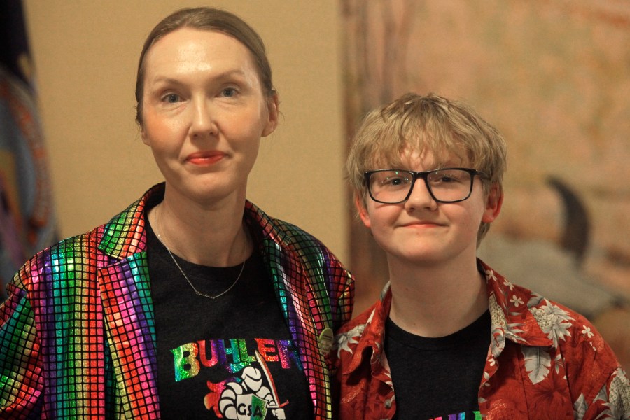 Cat Poland, of Buhler, Kansas, poses with her 13-year-old trans son, Alex, after a day of lobbying by LGBTQ youth and their advocates at the Statehouse, Tuesday, March 28, 2023, in Topeka, Kan. Alex runs cross country and hopes to play baseball next year, and he and his mother are frustrated with multiple bills seeking to roll back LGBTQ rights in the Kansas Legislature, including one to ban transgender athletes from girls' and women's sports. (AP Photo/John Hanna)