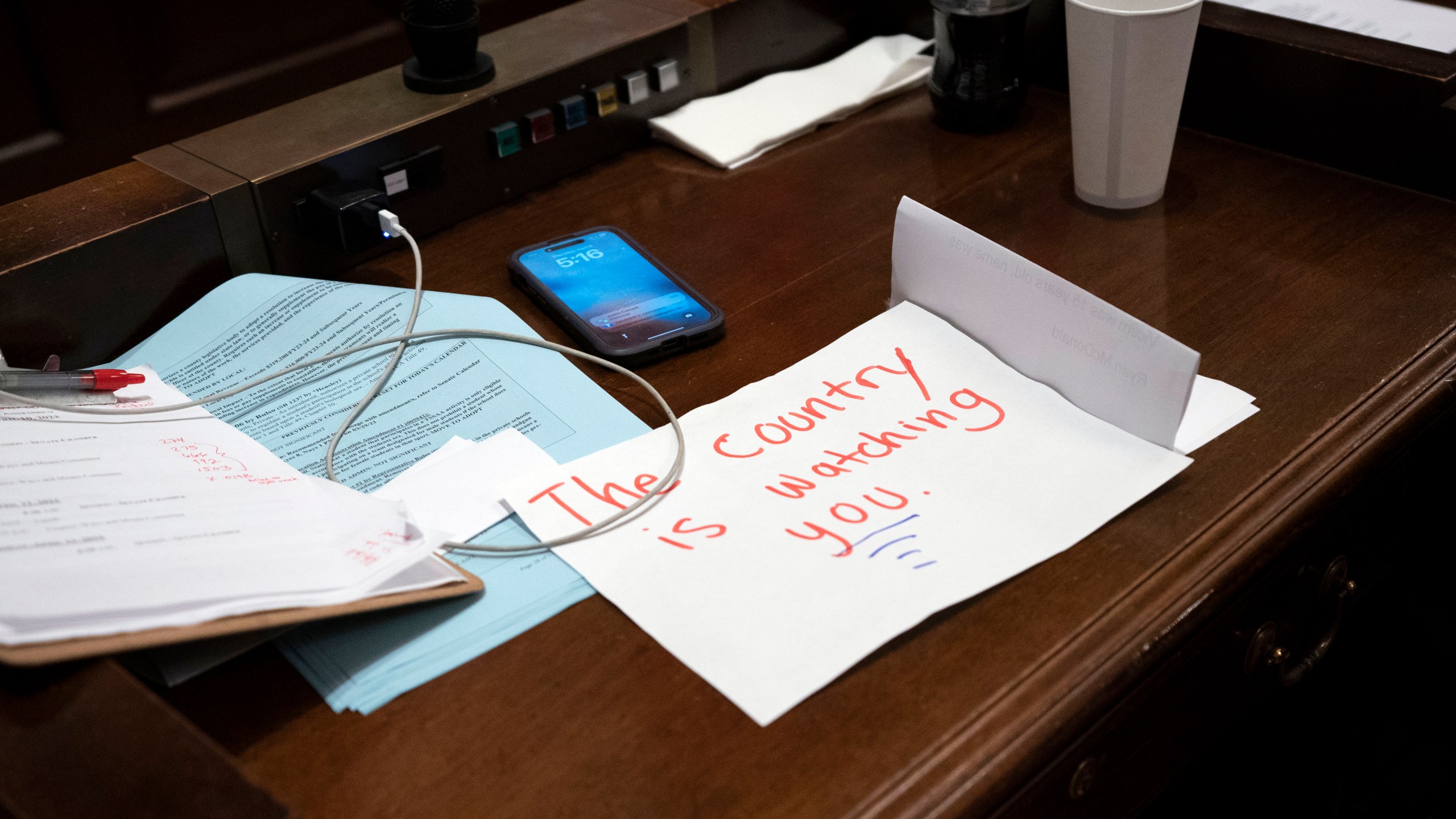 A sign rests on the desk of Rep. Gloria Johnson, D-Knoxville, in the House chamber as proceedings were brought to expel her from the legislature Thursday, April 6, 2023, in Nashville, Tenn. In an extraordinary act of political retaliation, Tennessee Republicans on Thursday expelled Rep. Justin Jones, a Democratic lawmaker from the state Legislature for his role in a protest that called for more gun control in the aftermath of a deadly school shooting in Nashville. Rep. Gloria Johnson narrowly avoided being removed. (AP Photo/George Walker IV)