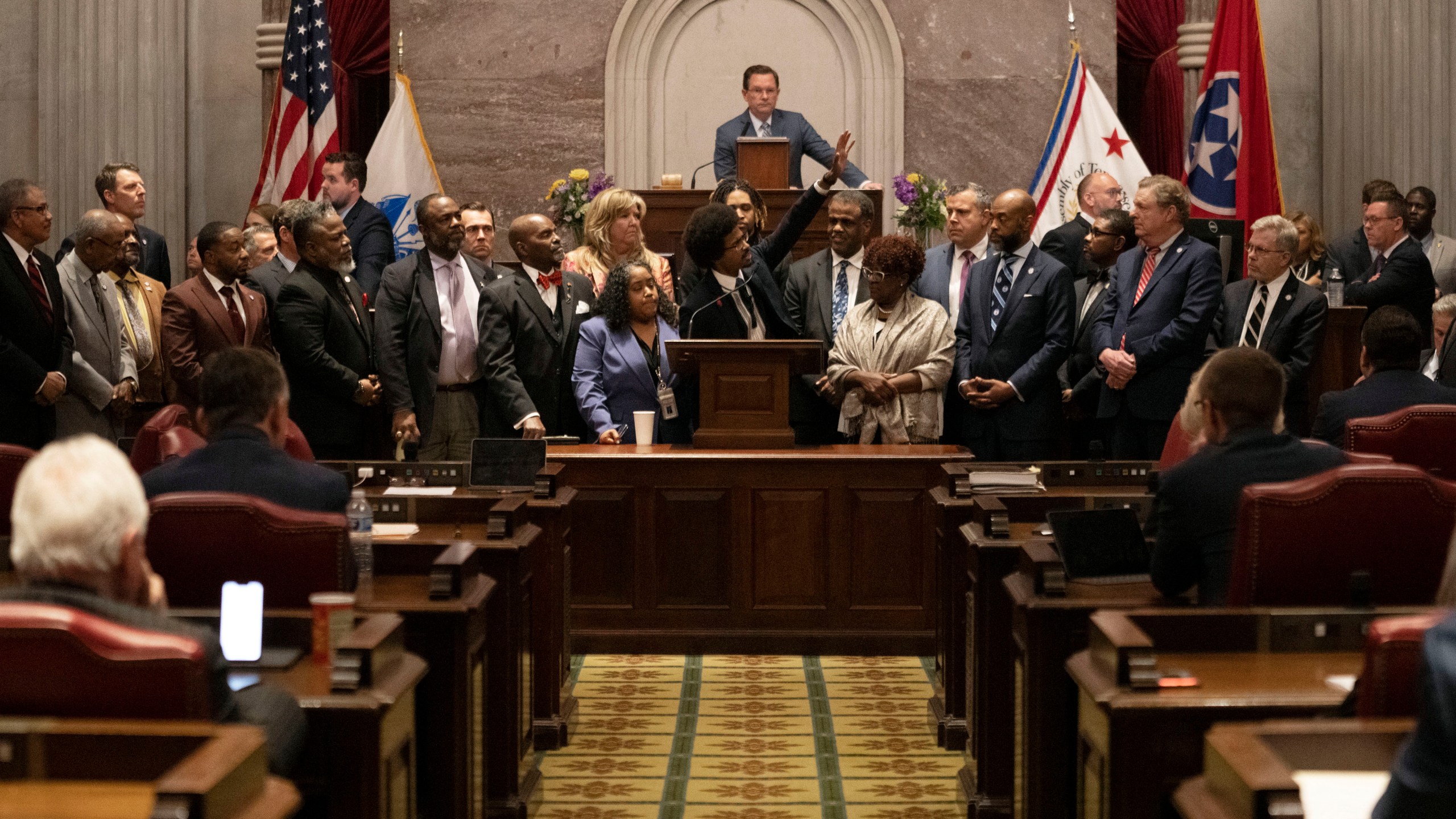 Former Rep. Justin Pearson, D-Memphis, waves to his supporters in the gallery as he delivers his final remarks on the floor of the House chamber as he is expelled from the legislature Thursday, April 6, 2023, in Nashville, Tenn. Tennessee Republicans ousted two of three House Democrats for using a bullhorn to shout support for pro-gun control protesters in the House chamber. (AP Photo/George Walker IV)