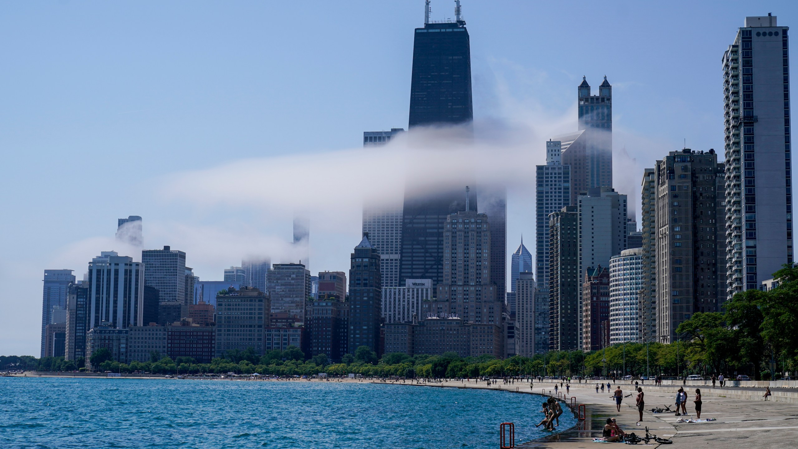 The Chicago city skyline is covered by the fog lifted off Lake Michigan on Aug. 5, 2022, in Chicago. Democrats have chosen Chicago to host their 2024 national convention. (AP Photo/Kiichiro Sato, File)