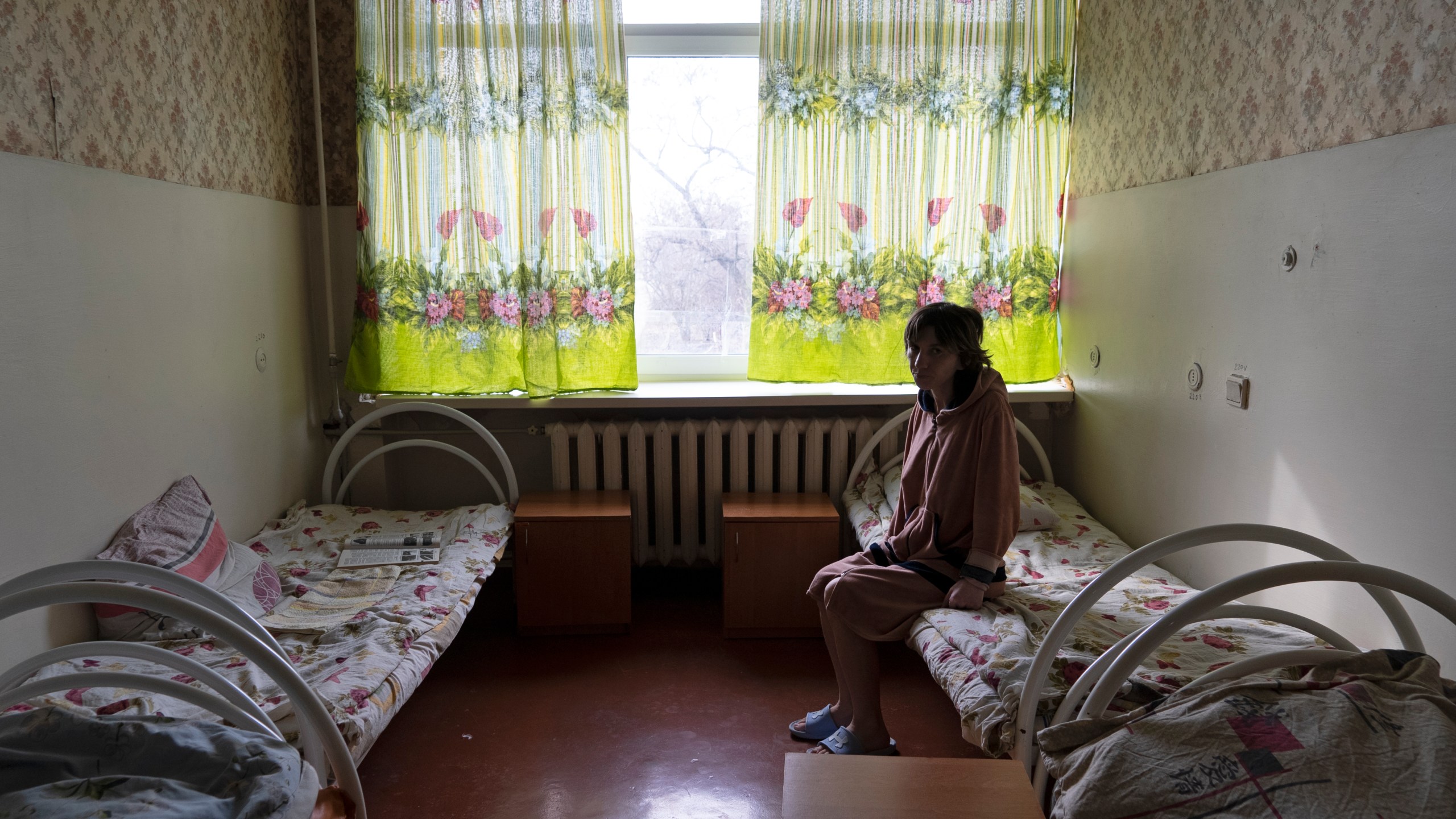 Natalia, 37, a patient, sits in her room at a psychiatric hospital in Kramatorsk, Ukraine, Tuesday March 21, 2023. In December, the World Health Organization said one in five people in countries that have experienced conflict in the past decade will suffer from a mental health condition, and estimated that about 9.6 million people in Ukraine could be affected. Russia’s invasion in February 2022 resulted in millions of people being displaced, bereaved, forced into basements for months due to incessant shelling or enduring harrowing journeys from Russian-occupied regions. (AP Photo/Vasilisa Stepanenko)