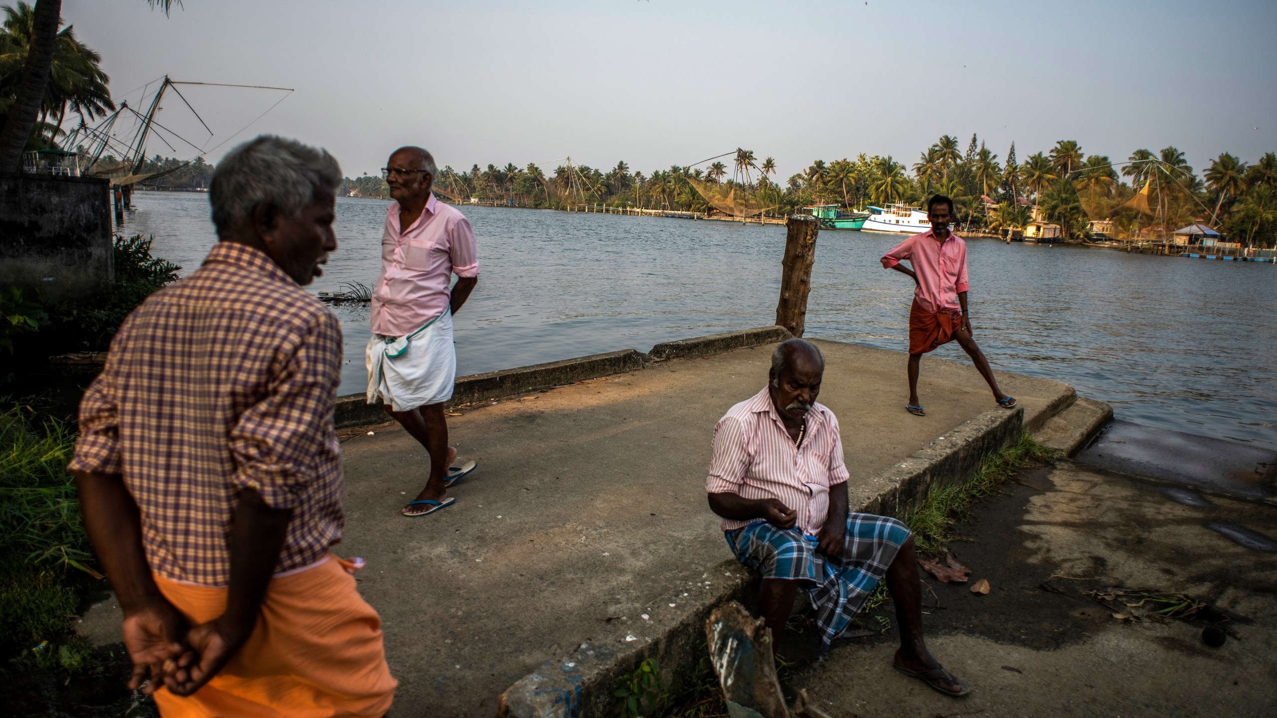 Elderly men idle away an evening by the backwaters in Kochi, Kerala state, India, March 10, 2023. In this coastal state in India's southern tip, the aging population provides a stark contrast to the young India of the north. The most literate state in India, Kerala is also the fastest aging part of the country. Declining fertility and increasing longevity have been contributing to the demographic shifts in the State. (AP Photo/ R S Iyer)