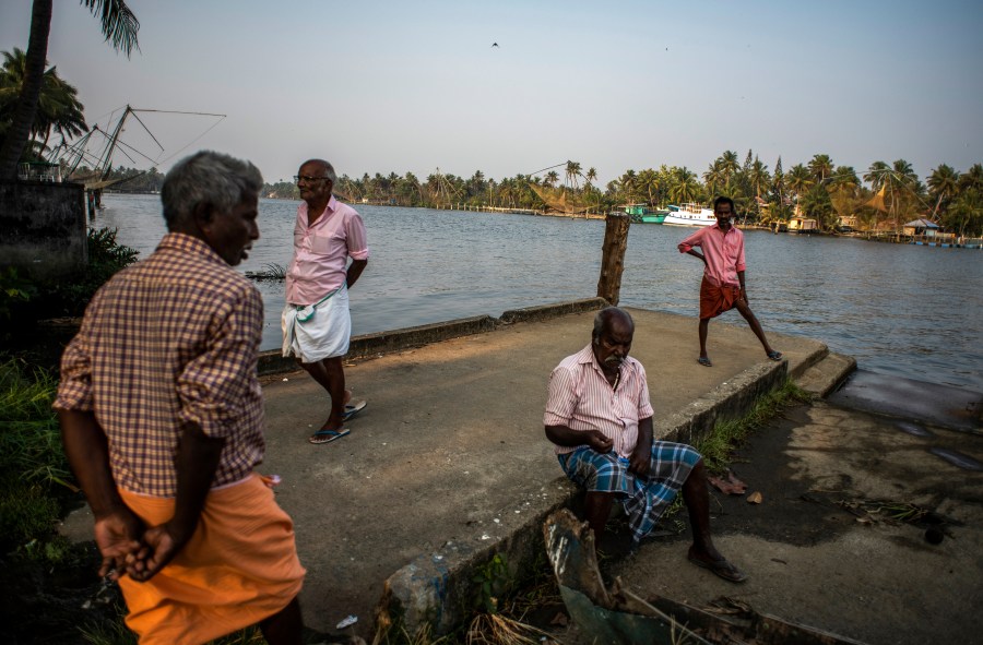 Elderly men idle away an evening by the backwaters in Kochi, Kerala state, India, March 10, 2023. In this coastal state in India's southern tip, the aging population provides a stark contrast to the young India of the north. The most literate state in India, Kerala is also the fastest aging part of the country. Declining fertility and increasing longevity have been contributing to the demographic shifts in the State. (AP Photo/ R S Iyer)