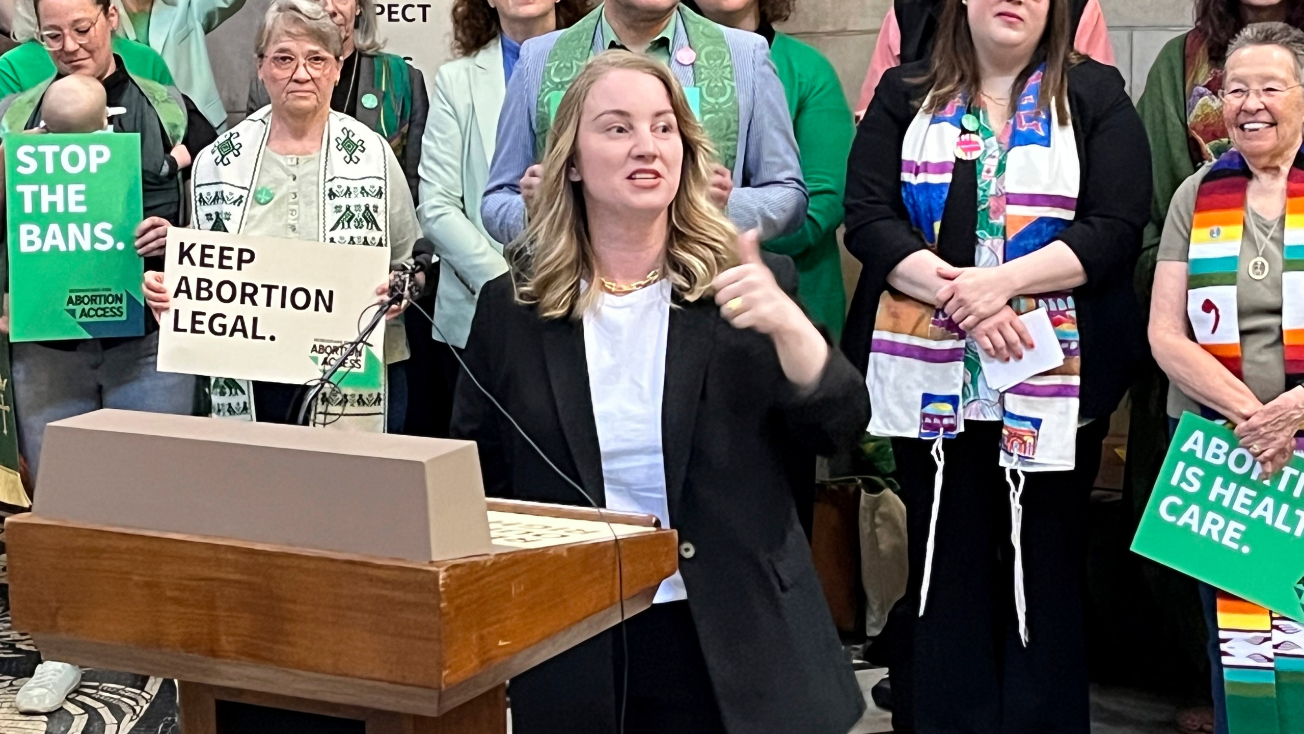 Nebraska state Sen. Megan Hunt addresses a crowd of about 200 people Wednesday, April 12, 2023, in the Nebraska state Capitol rotunda in Lincoln, Neb., during a rally to oppose a bill that would ban abortion once cardiac activity can be detected in an embryo, which is generally around the sixth week of pregnancy. (AP Photo/Margery Beck)