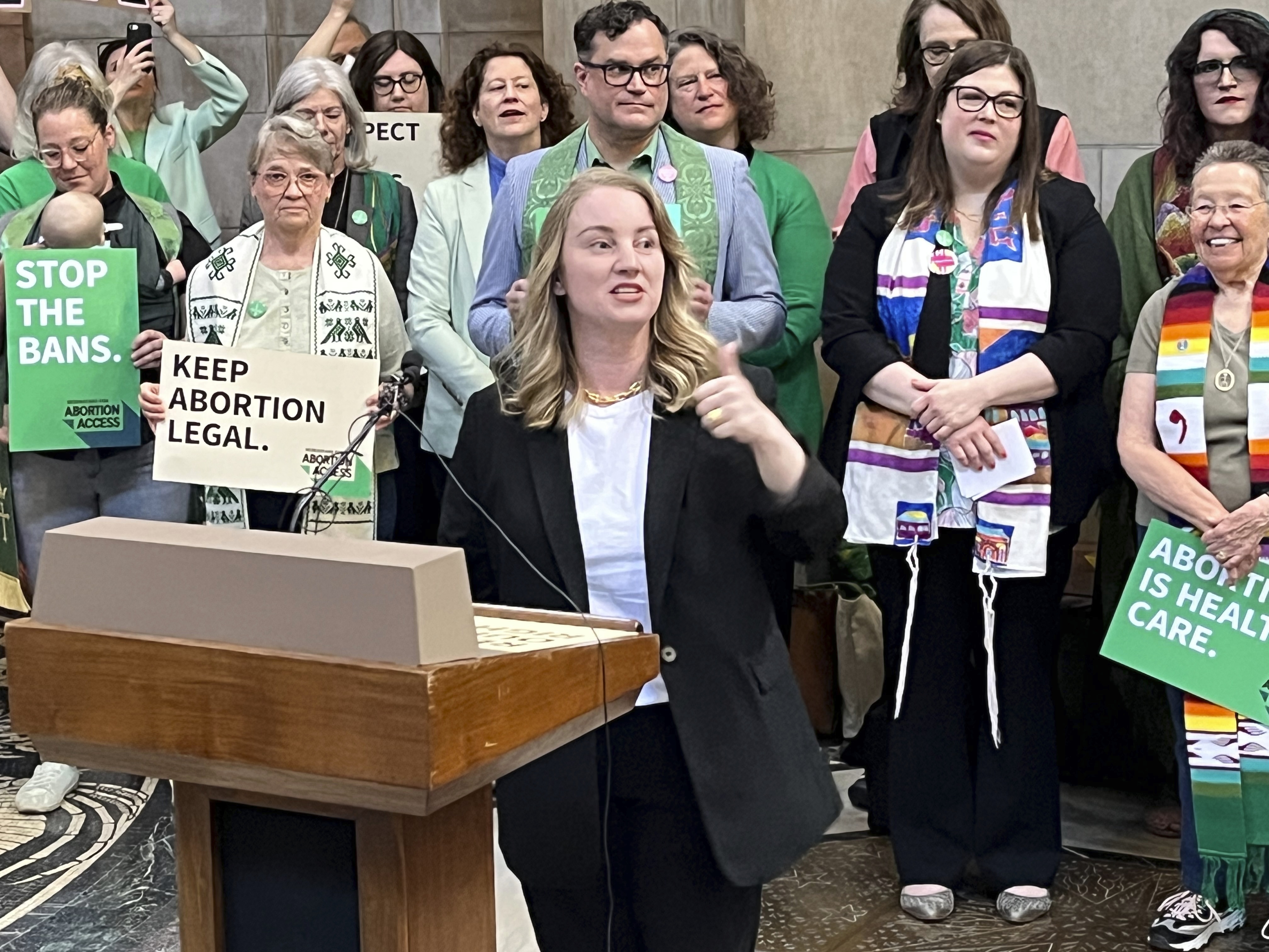 Nebraska state Sen. Megan Hunt addresses a crowd of about 200 people Wednesday, April 12, 2023, in the Nebraska state Capitol rotunda in Lincoln, Neb., during a rally to oppose a bill that would ban abortion once cardiac activity can be detected in an embryo, which is generally around the sixth week of pregnancy. (AP Photo/Margery Beck)