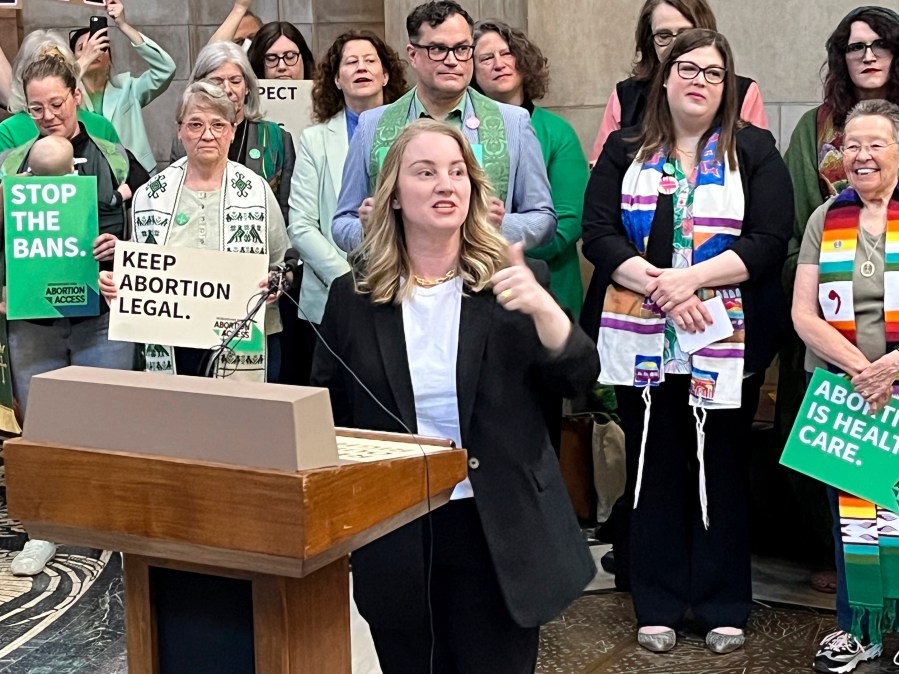 Nebraska state Sen. Megan Hunt addresses a crowd of about 200 people Wednesday, April 12, 2023, in the Nebraska state Capitol rotunda in Lincoln, Neb., during a rally to oppose a bill that would ban abortion once cardiac activity can be detected in an embryo, which is generally around the sixth week of pregnancy. (AP Photo/Margery Beck)