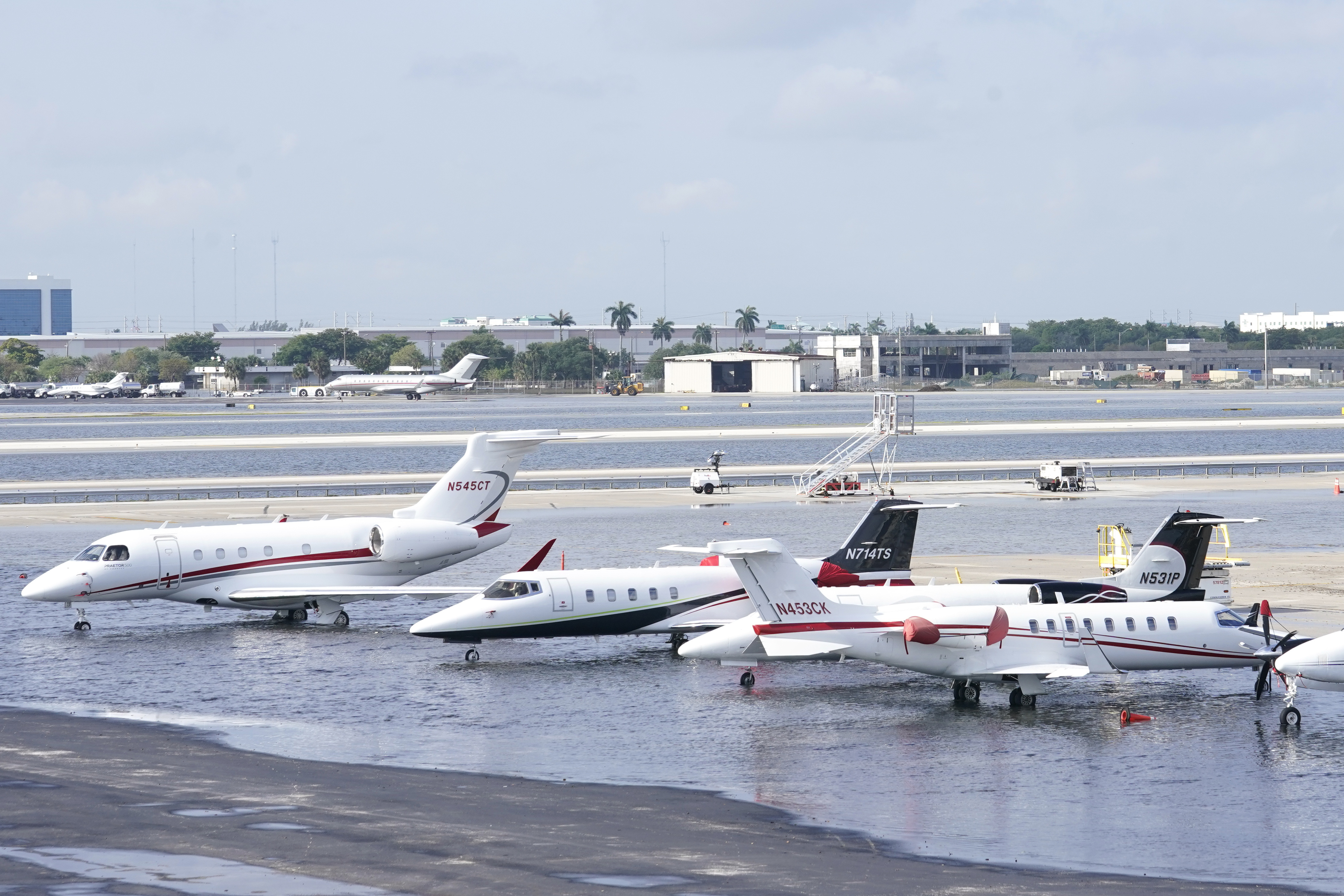 Small planes are parked at Fort Lauderdale- Hollywood International Airport, after the airport was force to shut down due to flooding, Thursday, April 13, 2023, in Fort Lauderdale, Fla. Fort Lauderdale issued a state of emergency as flood conditions continued through many areas. Over 25 inches of rain fell in South Florida since Monday causing widespread flooding. (AP Photo/Marta Lavandier)