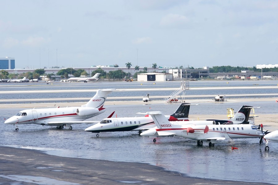 Small planes are parked at Fort Lauderdale- Hollywood International Airport, after the airport was force to shut down due to flooding, Thursday, April 13, 2023, in Fort Lauderdale, Fla. Fort Lauderdale issued a state of emergency as flood conditions continued through many areas. Over 25 inches of rain fell in South Florida since Monday causing widespread flooding. (AP Photo/Marta Lavandier)