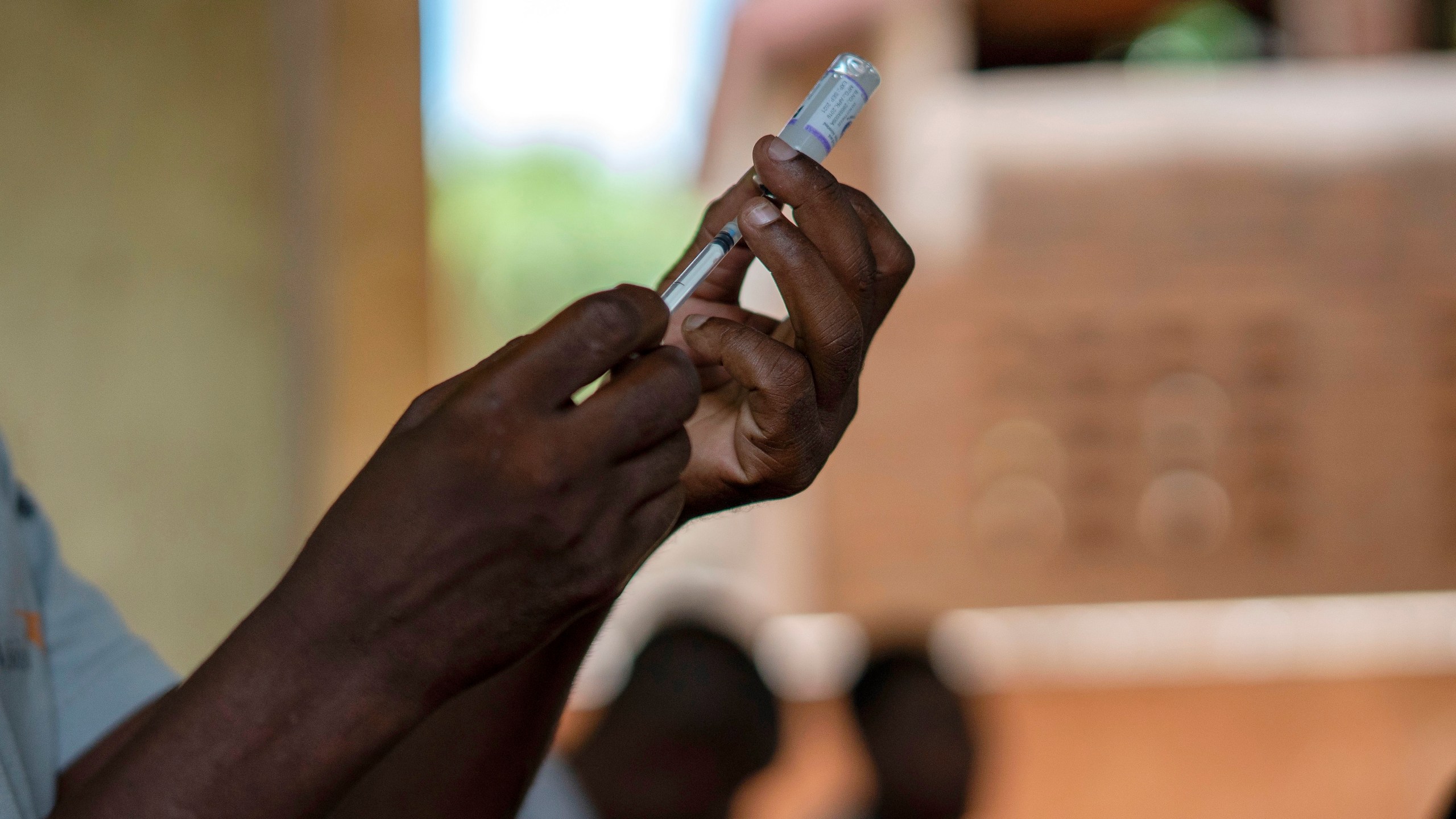 FILE - Health officials prepare to administer a vaccine in the Malawi village of Tomali with the world's first vaccine against malaria in a pilot program in Tomali, Dec. 11, 2019. The University of Oxford said Thursday April 13, 2023 that Ghana is the first country to approve a new Malaria vaccine in a "first crucial step" to helping children combat the disease. The vaccine —known as R21/Matrix-M — is not yet public, but Ghana's Food and Drug Authority has granted full approval for children between five and 36 months(AP Photo/Jerome Delay, File)