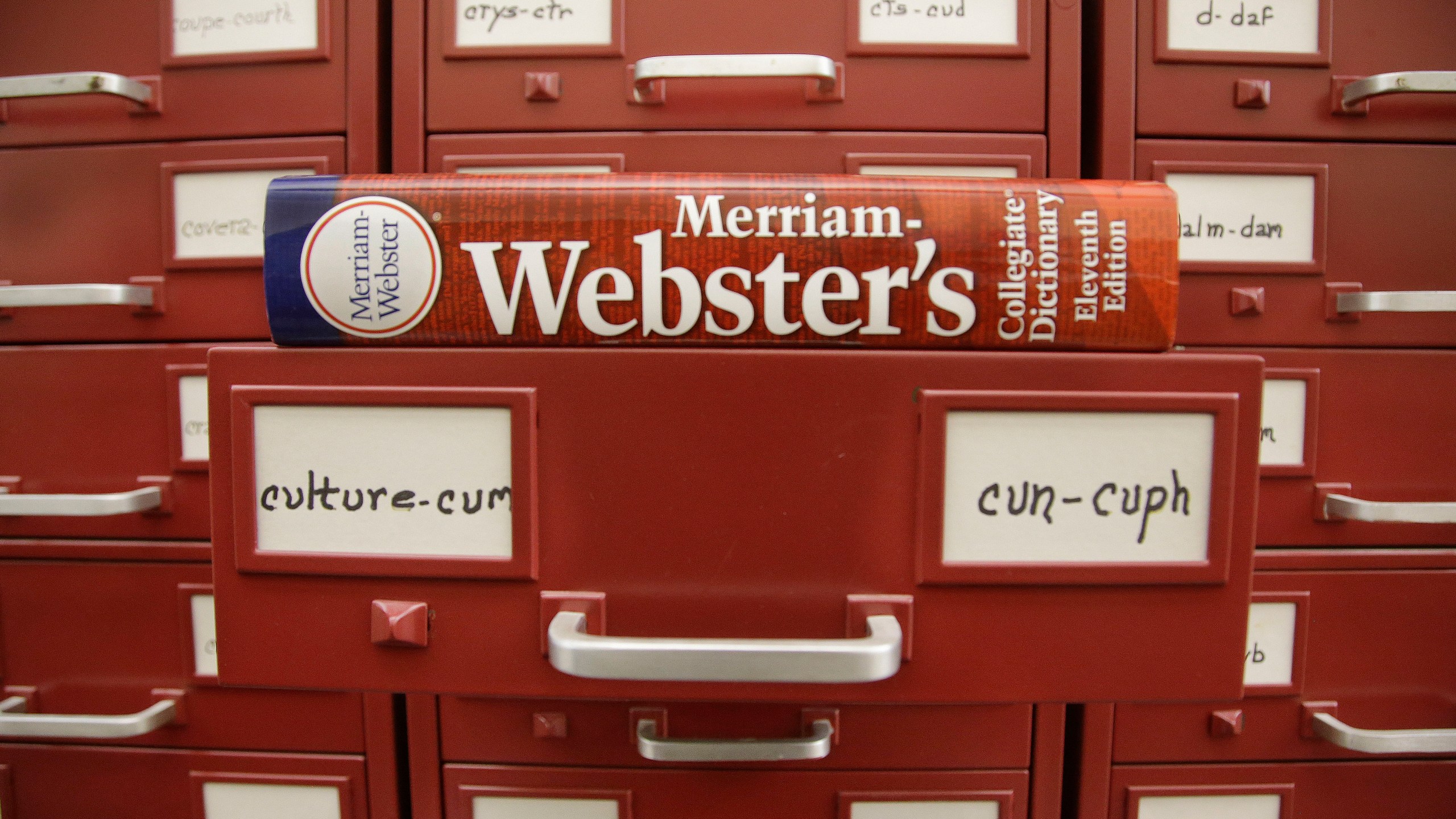 FILE - A Merriam-Webster dictionary sits atop their citation files at the dictionary publisher's offices on Dec. 9, 2014, in Springfield, Mass. A California man who admitted to making violent anti-LGBTQ threats against dictionary publisher Merriam-Webster Inc. over its updated gender definitions was sentenced in a federal courtroom in Massachusetts on Thursday, April 13, 2023, to a year in prison. (AP Photo/Stephan Savoia, File)