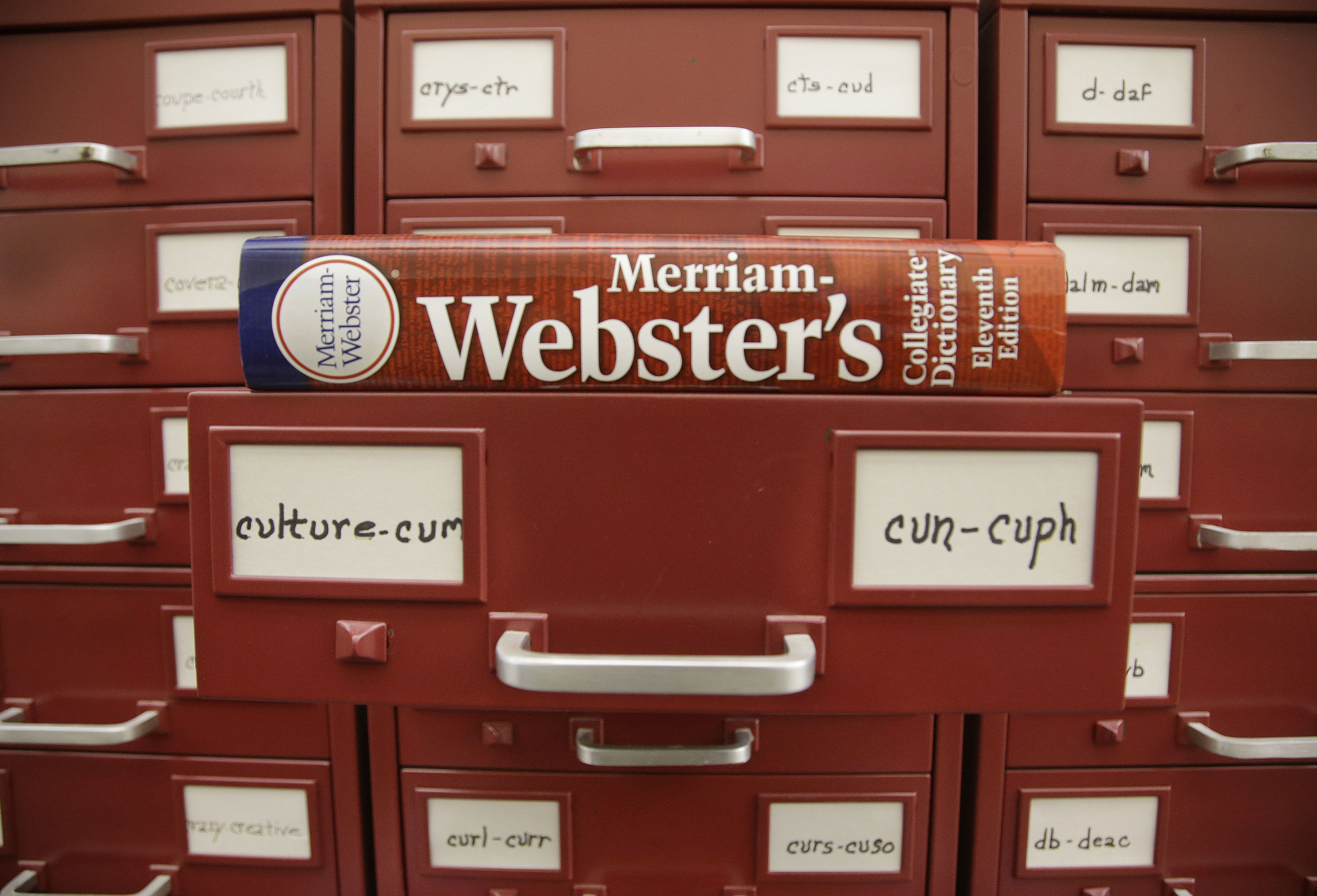 FILE - A Merriam-Webster dictionary sits atop their citation files at the dictionary publisher's offices on Dec. 9, 2014, in Springfield, Mass. A California man who admitted to making violent anti-LGBTQ threats against dictionary publisher Merriam-Webster Inc. over its updated gender definitions was sentenced in a federal courtroom in Massachusetts on Thursday, April 13, 2023, to a year in prison. (AP Photo/Stephan Savoia, File)