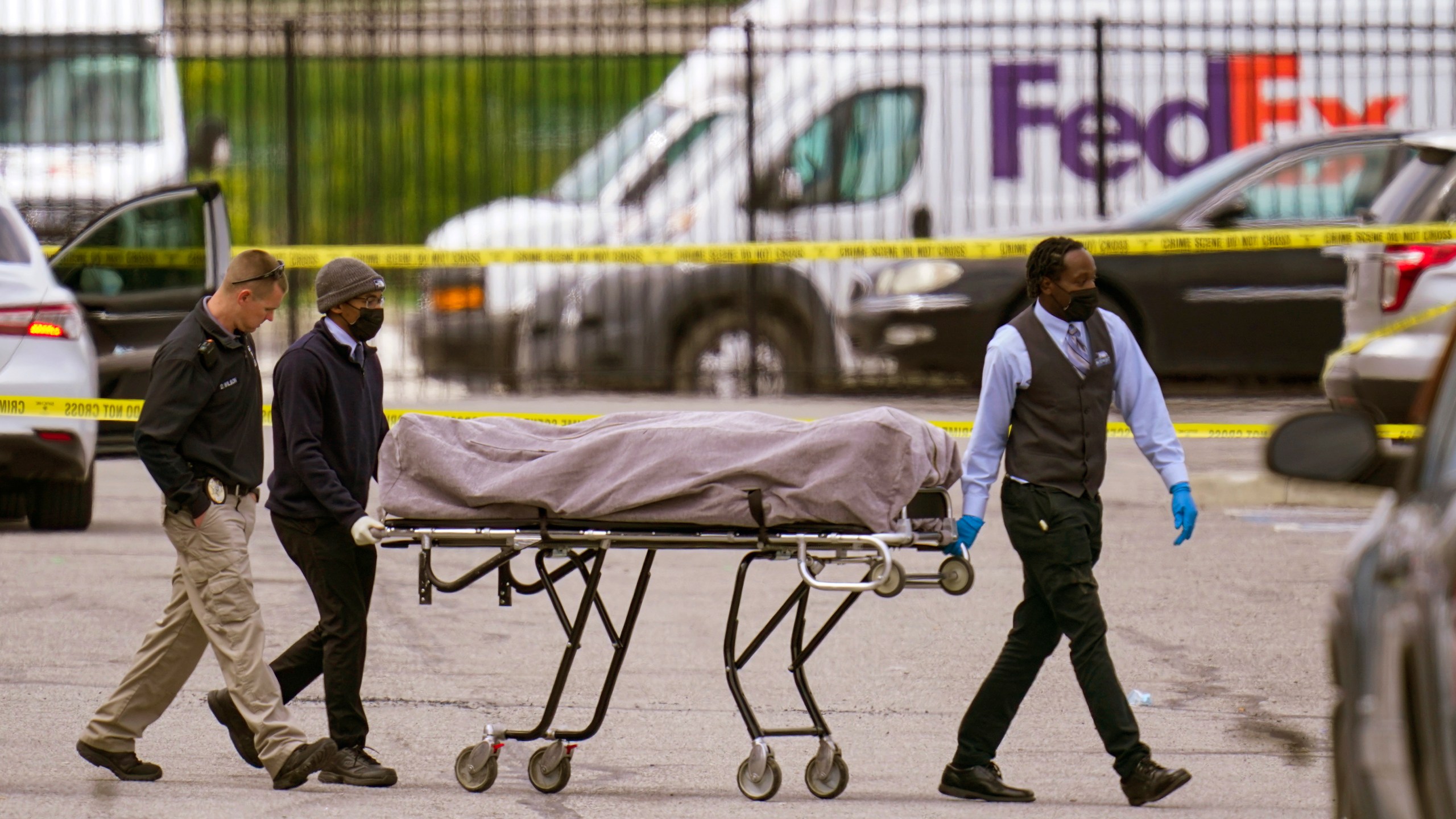 FILE - A body is taken from the scene where multiple people were shot at a FedEx Ground facility in Indianapolis, April 16, 2021. The son of a man killed in the 2021 mass shooting at an Indianapolis FedEx facility filed a lawsuit Thursday, April 13, 2023, with two survivors against the distributor of the 60-round magazine used by the gunman, alleging the use of reckless marketing tactics targeting young men at risk for violent behavior. (AP Photo/Michael Conroy, File)