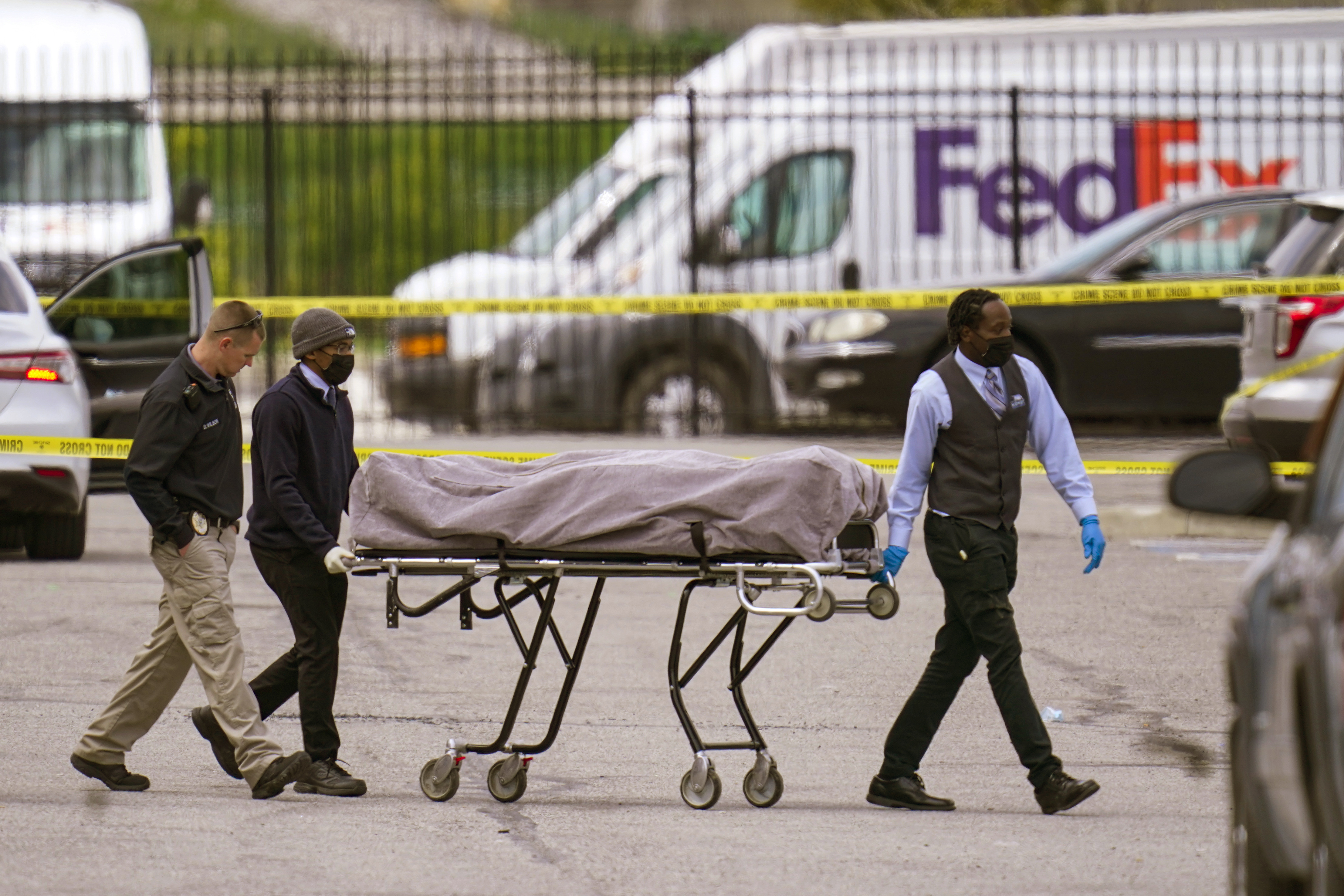 FILE - A body is taken from the scene where multiple people were shot at a FedEx Ground facility in Indianapolis, April 16, 2021. The son of a man killed in the 2021 mass shooting at an Indianapolis FedEx facility filed a lawsuit Thursday, April 13, 2023, with two survivors against the distributor of the 60-round magazine used by the gunman, alleging the use of reckless marketing tactics targeting young men at risk for violent behavior. (AP Photo/Michael Conroy, File)