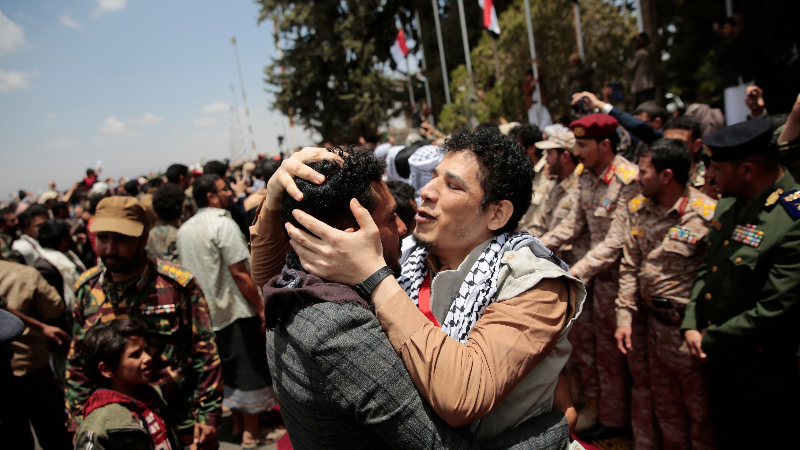 Houthi prisoners are greeted as they arrive to Sanaa airport, Friday, April 14, 2023. An exchange of more than 800 prisoners linked to Yemen's long-running war them began Friday, the International Committee for the Red Cross said. The three-day operations will see flights transport prisoners between Saudi Arabia and Yemen's capital, Sanaa, long held by the Iranian-backed Houthi rebels. ((AP Photo/Hani Mohammed)