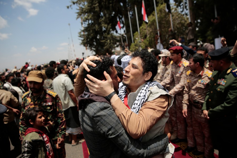 Houthi prisoners are greeted as they arrive to Sanaa airport, Friday, April 14, 2023. An exchange of more than 800 prisoners linked to Yemen's long-running war them began Friday, the International Committee for the Red Cross said. The three-day operations will see flights transport prisoners between Saudi Arabia and Yemen's capital, Sanaa, long held by the Iranian-backed Houthi rebels. ((AP Photo/Hani Mohammed)