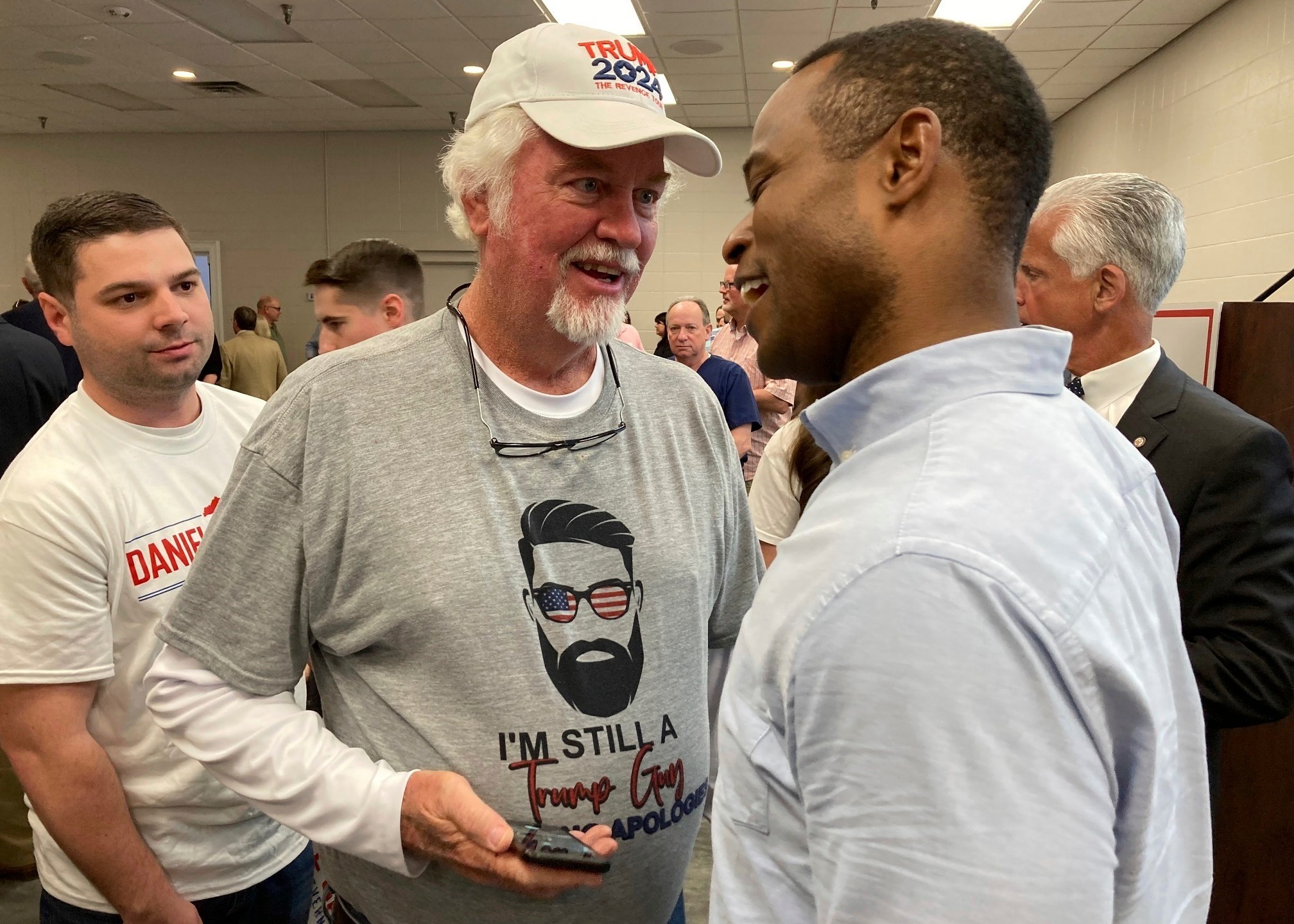 Republican gubernatorial candidate Daniel Cameron, right, speaks with voters after a campaign rally in Louisville, Ky., Wednesday, April 12, 2023. Cameron reaffirmed his support for gun rights in the aftermath of the mass shooting in Louisville. (AP Photo/Bruce Schreiner)