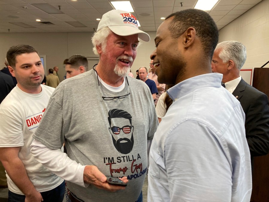 Republican gubernatorial candidate Daniel Cameron, right, speaks with voters after a campaign rally in Louisville, Ky., Wednesday, April 12, 2023. Cameron reaffirmed his support for gun rights in the aftermath of the mass shooting in Louisville. (AP Photo/Bruce Schreiner)