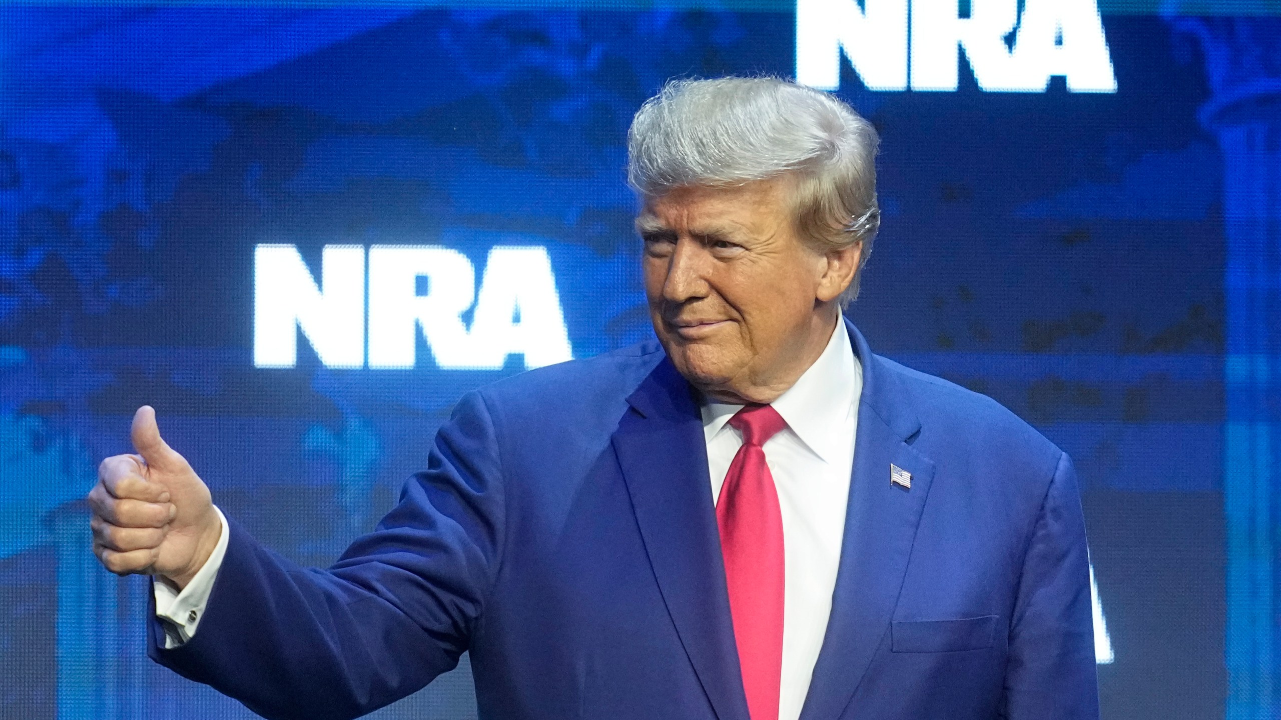 Former President Donald Trump reacts to the crowd before speaking during the National Rifle Association Convention, Friday, April 14, 2023, in Indianapolis. (AP Photo/Darron Cummings)