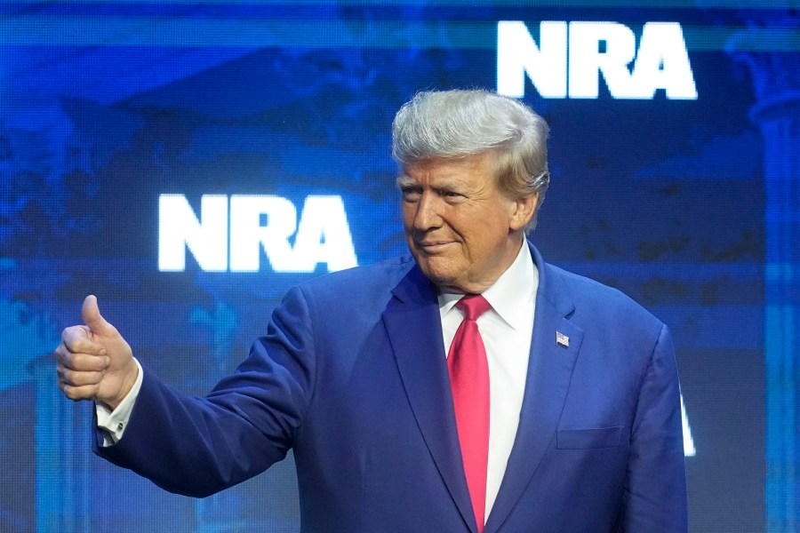 Former President Donald Trump reacts to the crowd before speaking during the National Rifle Association Convention, Friday, April 14, 2023, in Indianapolis. (AP Photo/Darron Cummings)