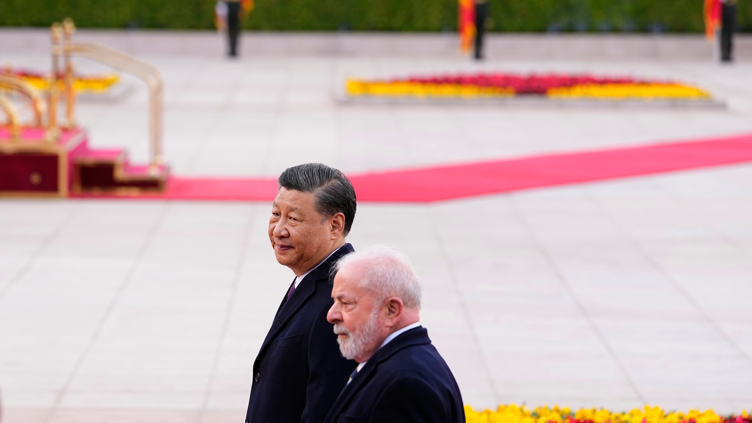 Brazilian President Luiz Inacio Lula da Silva, right, and Chinese President Xi Jinping walk during a welcome ceremony outside the Great Hall of the People in Beijing Friday, April 14, 2023. (Ken Ishii/Pool Photo via AP)