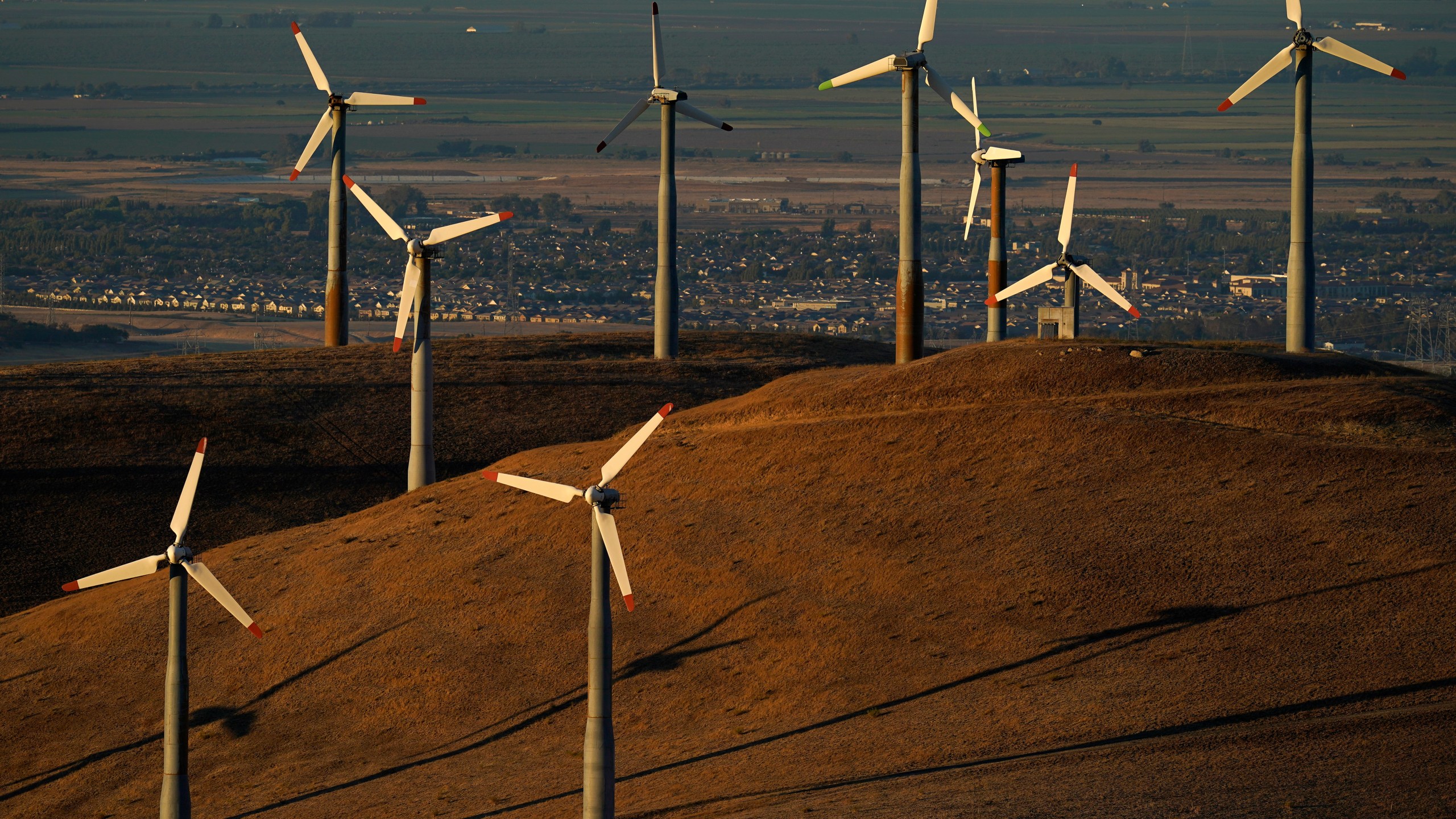 File - Wind turbines operate in Livermore, Calif., on Wednesday, Aug. 10, 2022. Across Europe companies are weighing up the U.S. Inflation Reduction Act's $375 billion in benefits for renewable industries against the European Union's fragmented response. (AP Photo/Godofredo A. Vásquez, File)