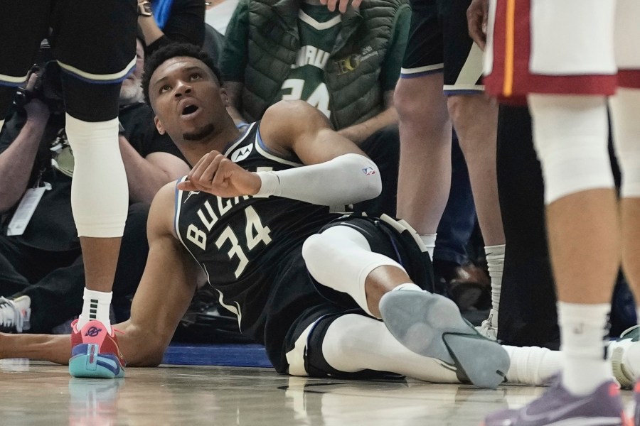 Milwaukee Bucks' Giannis Antetokounmpo lays on the ground after an injury during the first half in Game 1 of an NBA basketball first-round playoff game Sunday, April 16, 2023, in Milwaukee. (AP Photo/Morry Gash)