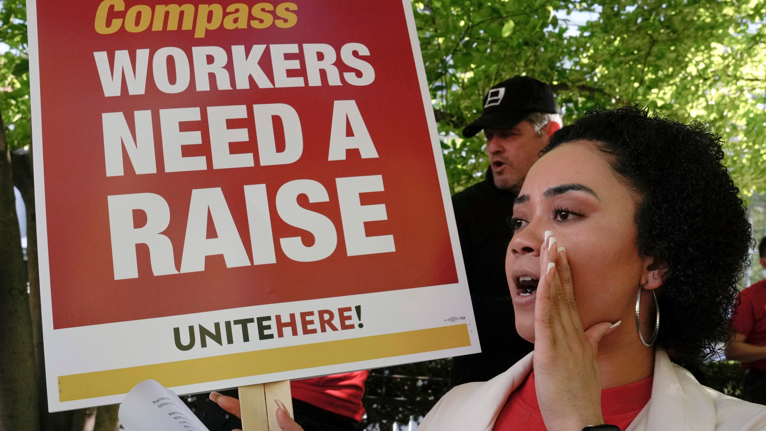 Workers who are contracted to feed World Bank employees through a firm called the Compass Group, protest for higher wages and affordable healthcare benefits, Wednesday, April 12, 2023, outside of the World Bank in Washington. (AP Photo/Mariam Zuhaib)