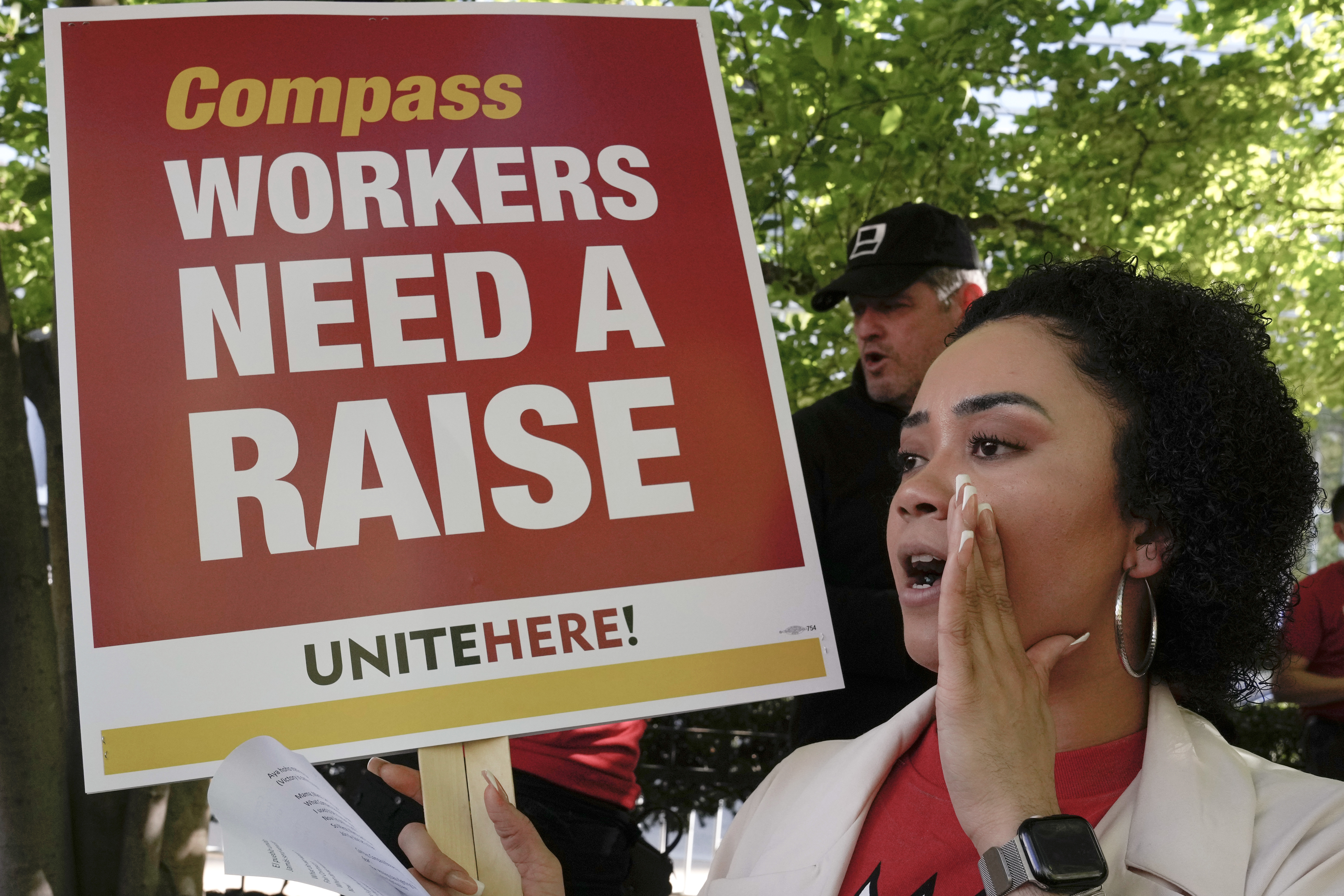 Workers who are contracted to feed World Bank employees through a firm called the Compass Group, protest for higher wages and affordable healthcare benefits, Wednesday, April 12, 2023, outside of the World Bank in Washington. (AP Photo/Mariam Zuhaib)