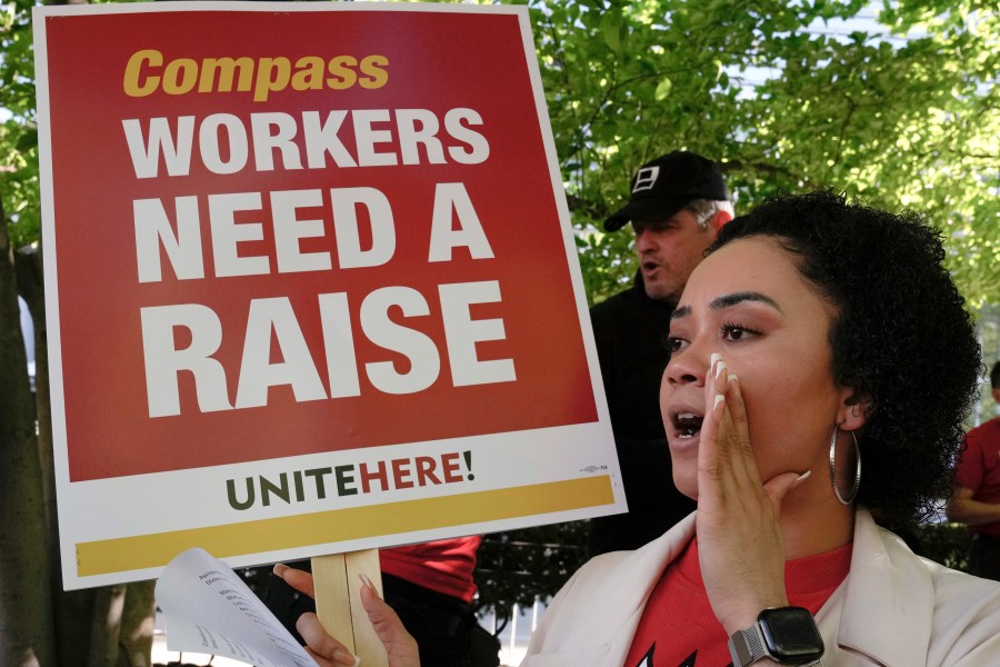 Workers who are contracted to feed World Bank employees through a firm called the Compass Group, protest for higher wages and affordable healthcare benefits, Wednesday, April 12, 2023, outside of the World Bank in Washington. (AP Photo/Mariam Zuhaib)