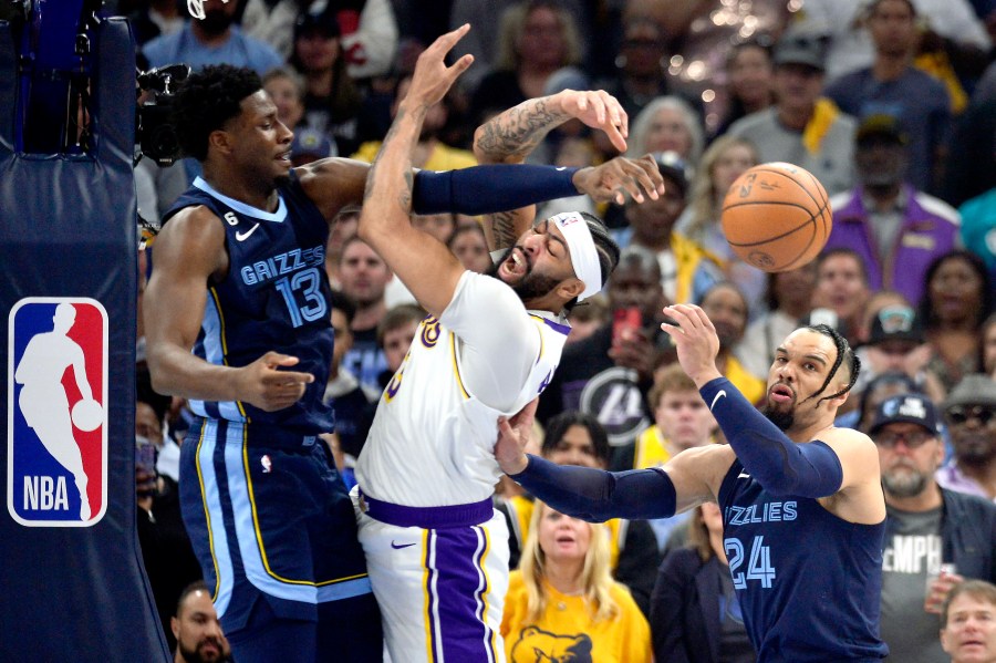 Los Angeles Lakers forward Anthony Davis (3), center, loses control of the ball between Memphis Grizzlies forwards Jaren Jackson Jr. (13) and Dillon Brooks (24) during Game 1 of a first-round NBA basketball playoff series Sunday, April 16, 2023, in Memphis, Tenn. (AP Photo/Brandon Dill)