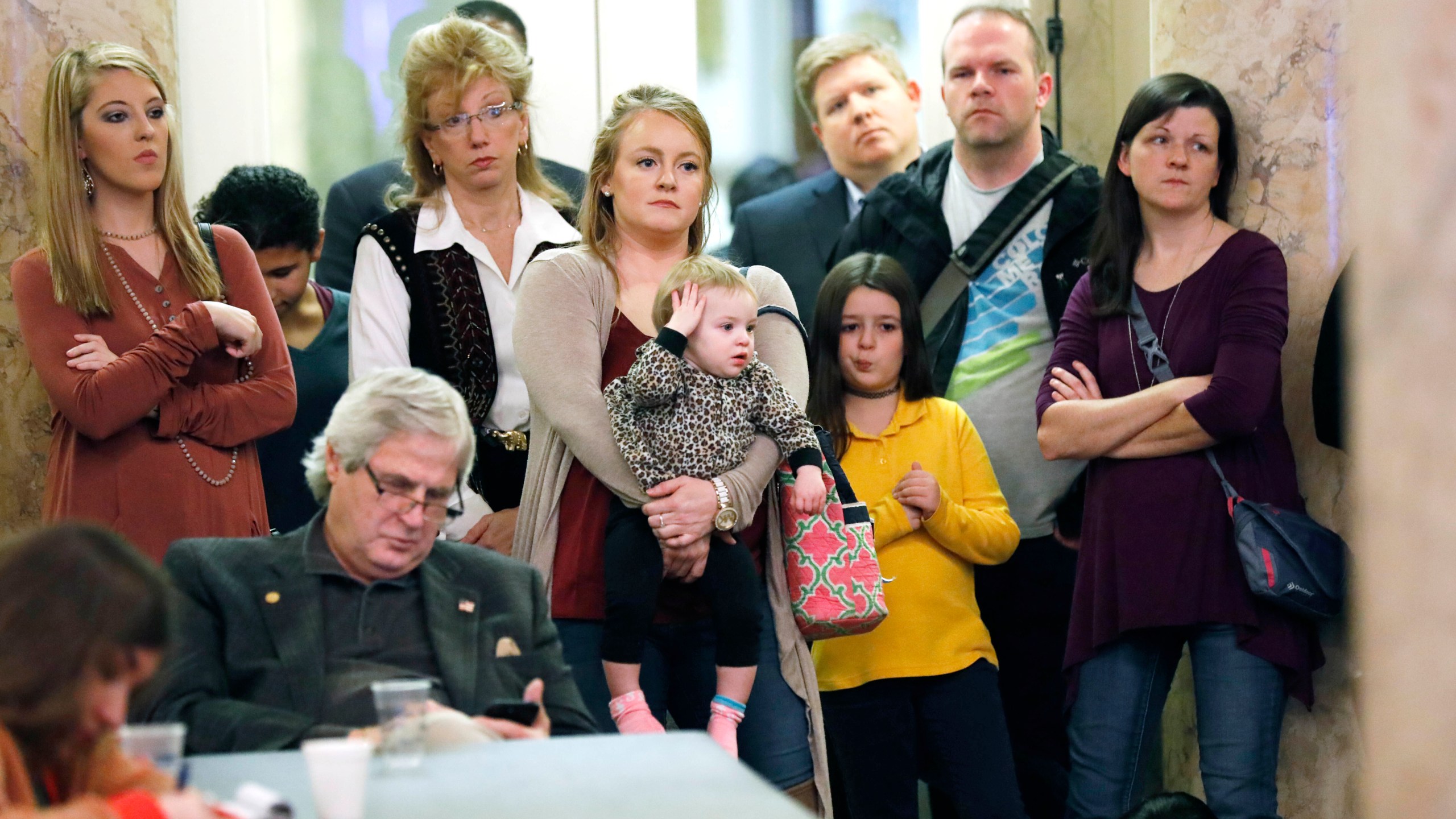 FILE - Parents with their children and medical professionals listen to testimony from proponents for allowing exemption from the vaccination requirement for school attendance based on religious beliefs during a meeting of House Judiciary B Committee, Jan. 24, 2018, at the Capitol in Jackson, Miss. A federal judge ruled Monday, April 17, 2023, that Mississippi must join most other states in allowing religious exemptions from vaccinations required before children can enroll in school. (AP Photo/Rogelio V. Solis, File)