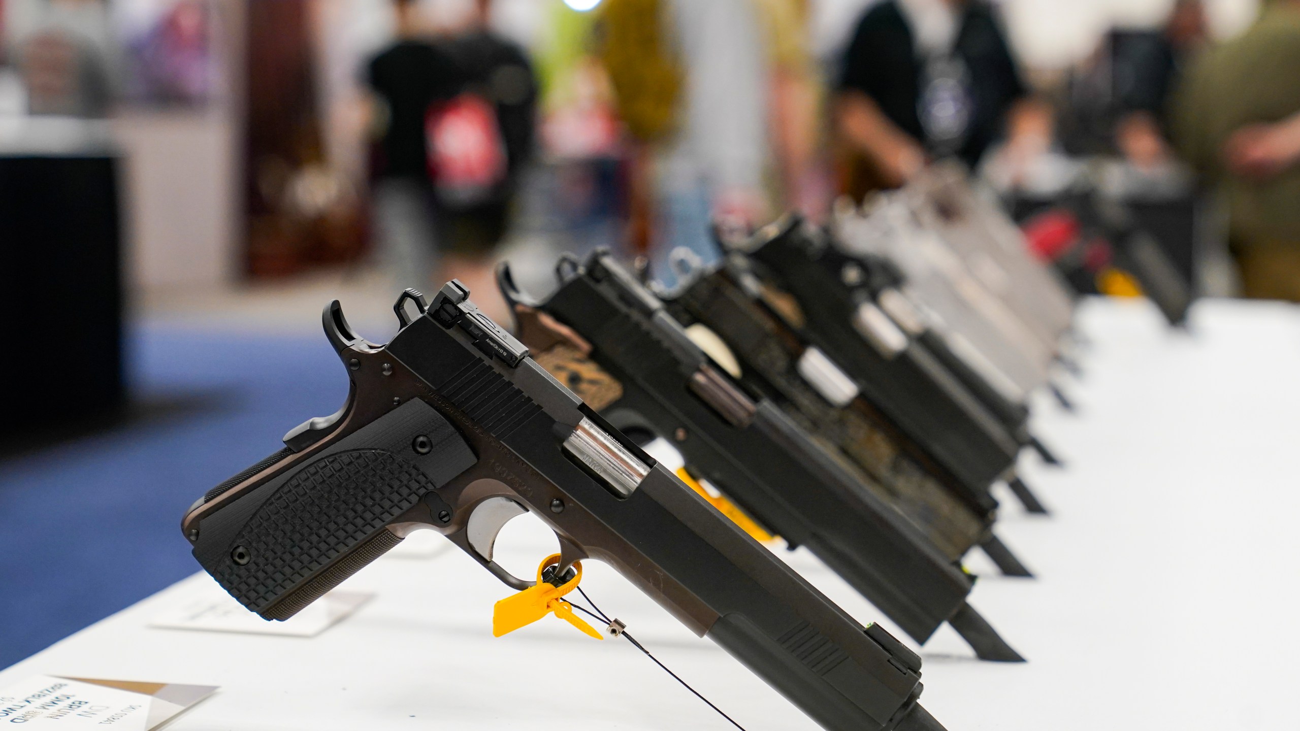 FILE - An array of pistols are shown in the Dan Wesson display as guests browse firearms at the National Rifle Association's Annual Meetings & Exhibits in Indianapolis, April 16, 2023. The roster of Republican presidential hopefuls who flocked to the National Rifle Association's annual convention reflects the political potency of gun rights, despite the group's eroding revenues and an opposition movement that's growing increasingly vocal as the drumbeat of mass shootings marches on.(AP Photo/Michael Conroy, File)