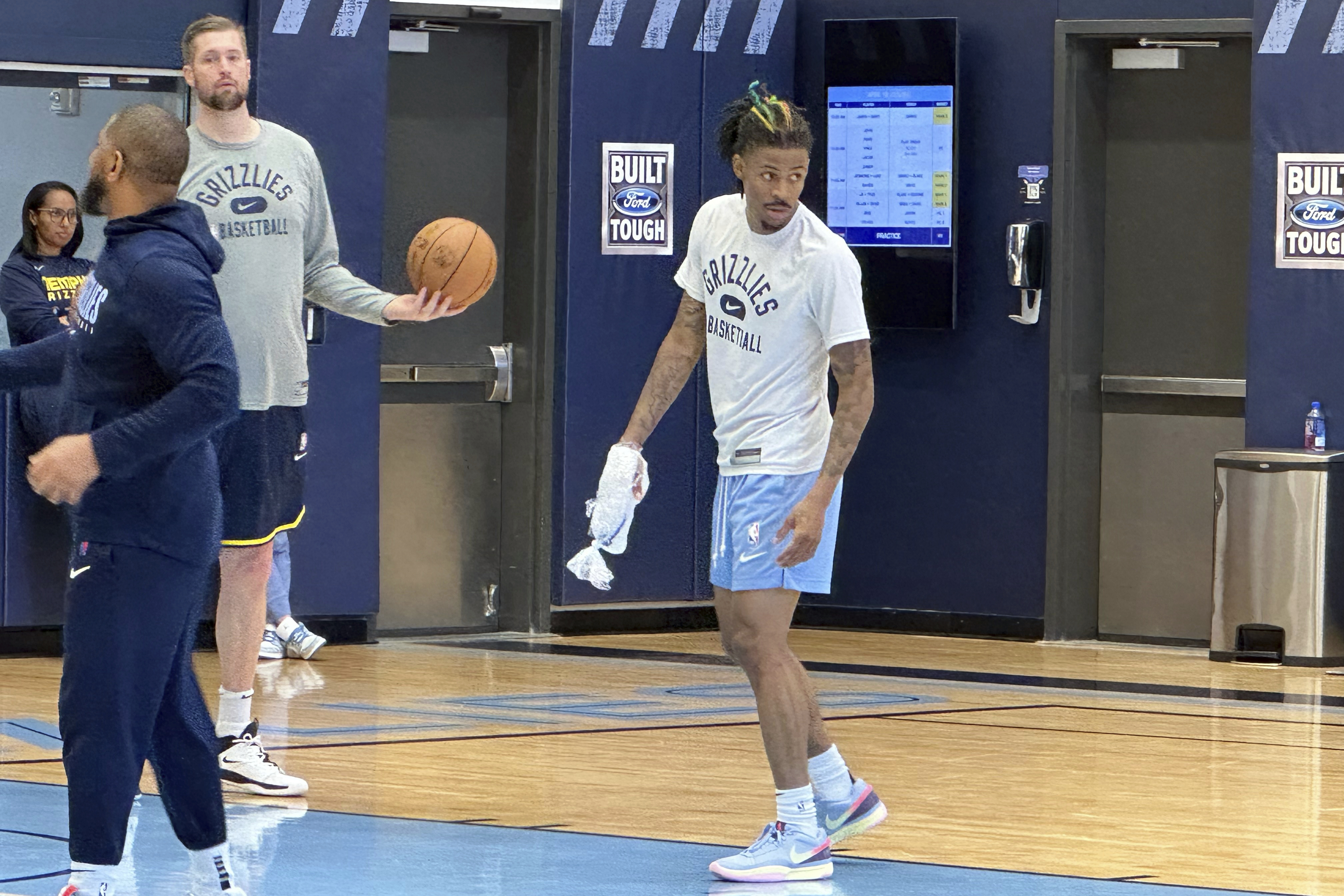 Memphis Grizzlies guard Ja Morant ices his right hand at the end of NBA basketball practice Tuesday, April 18, 2023. Morant had an MRI that showed no ligament damage after he landed awkwardly on his right hand in a loss to the Los Angeles Lakers in Game 1 in the first round of the playoffs Sunday. Coach Taylor Jenkins said Morant is a game-time decision dealing with soft tissue bruising between the bones. (AP Photo/Teresa M. Walker)