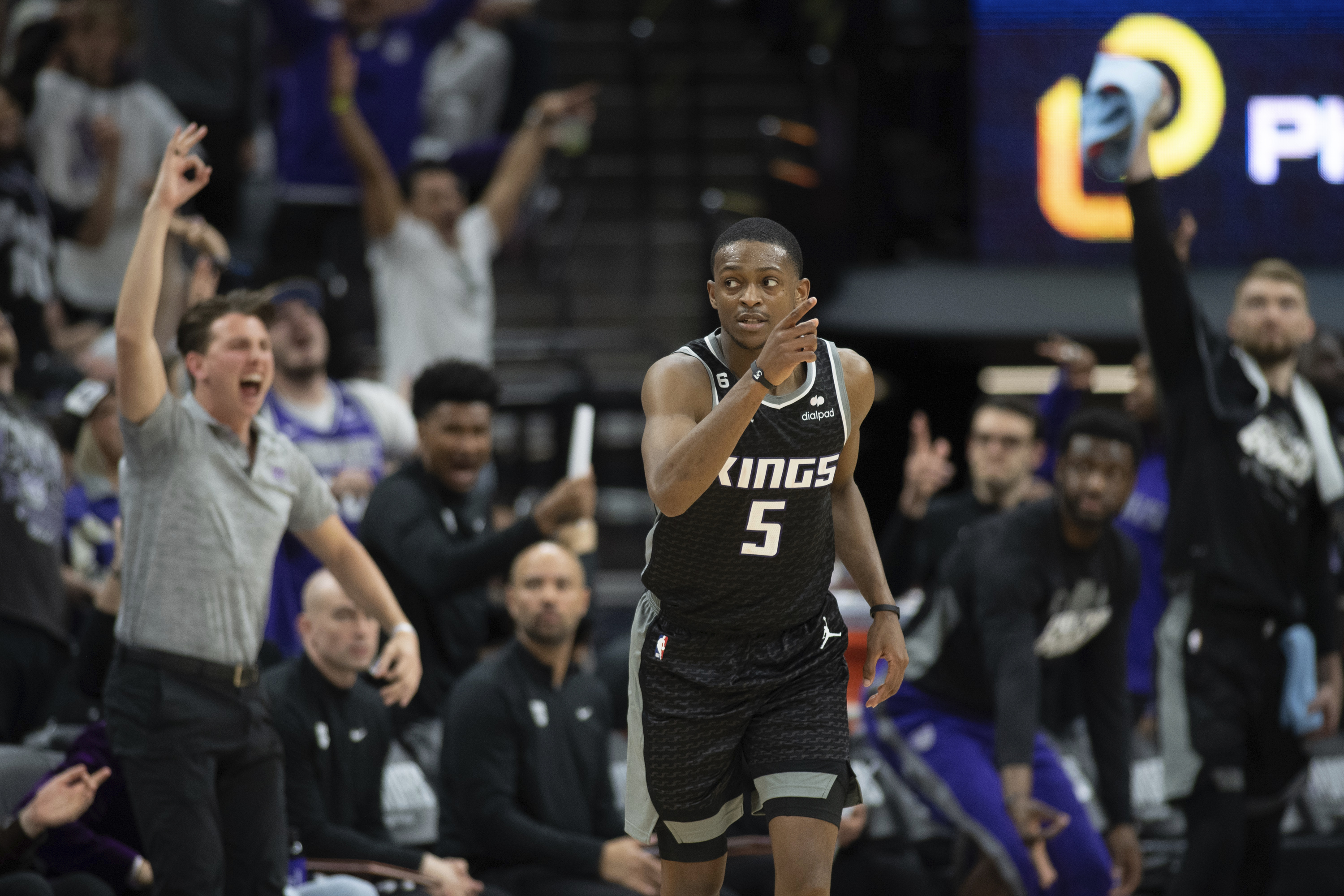 Sacramento Kings guard De'Aaron Fox (5) reacts after making a 3-point basket in the third quarter during Game 1 against the Golden State Warriors in the first round of the NBA basketball playoffs in Sacramento, Calif., Saturday, April 15, 2023. The Kings won 126 - 123. (AP Photo/José Luis Villegas)