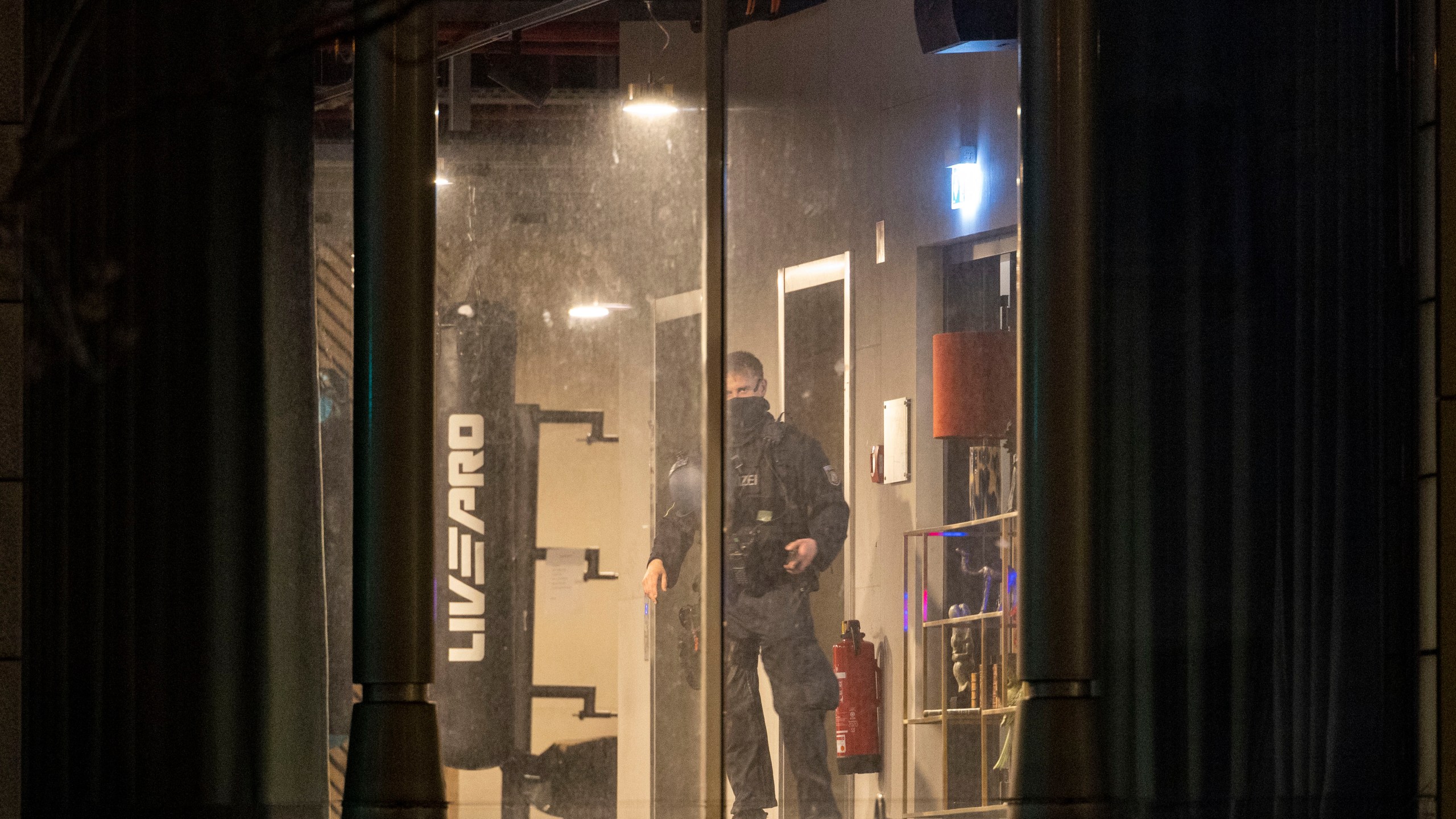 A police officer inspects a gym, the site of a stabbing attack, in a building in Duisburg, Germany, Tuesday, April 18, 2023. Several people were severely injured in a stabbing attack at a gym in the western German city of Duisburg, police said Tuesday evening. (Christoph Reichwein/dpa via AP)