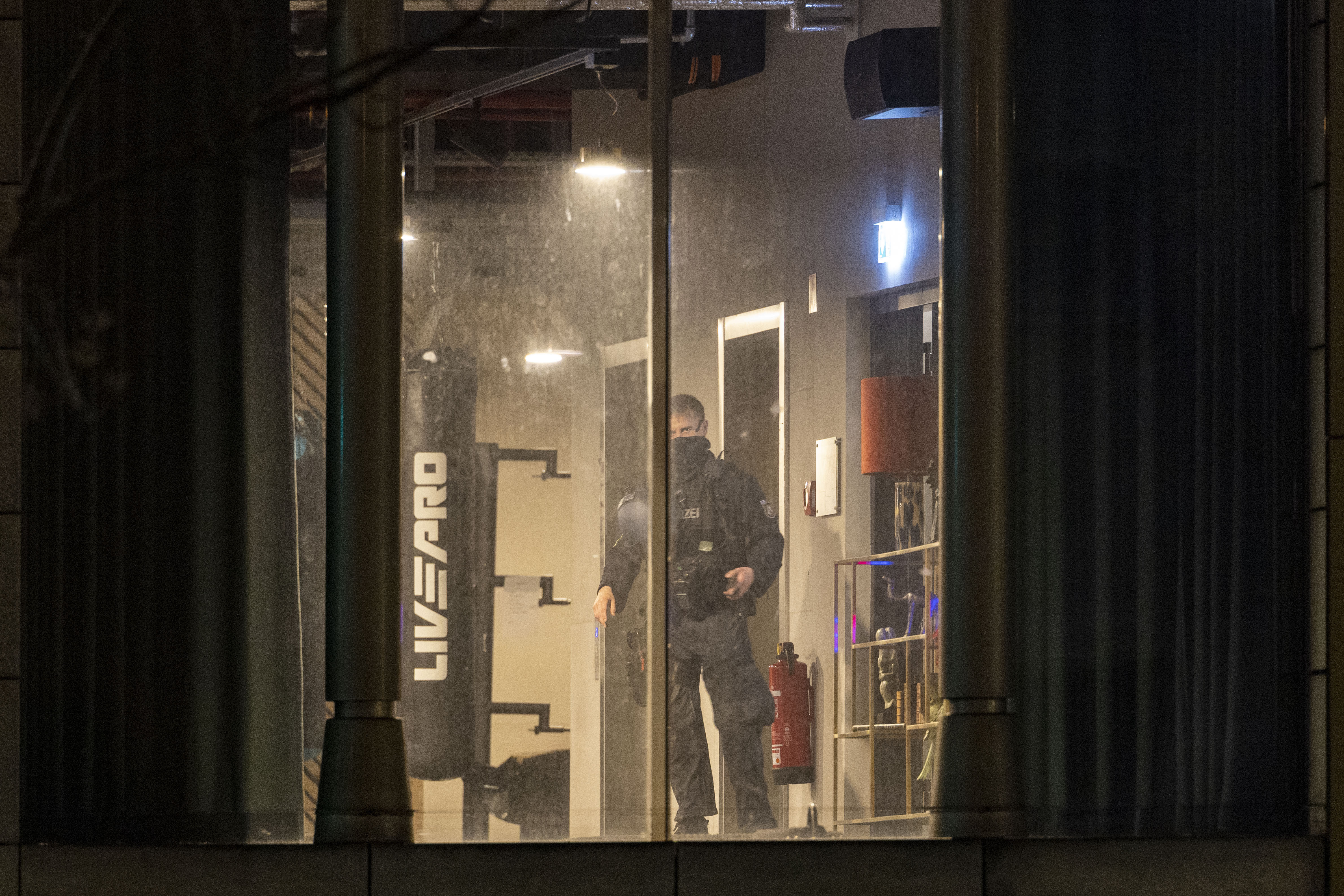 A police officer inspects a gym, the site of a stabbing attack, in a building in Duisburg, Germany, Tuesday, April 18, 2023. Several people were severely injured in a stabbing attack at a gym in the western German city of Duisburg, police said Tuesday evening. (Christoph Reichwein/dpa via AP)