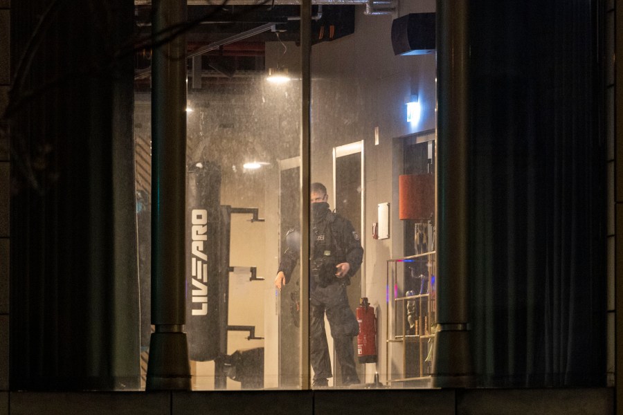 A police officer inspects a gym, the site of a stabbing attack, in a building in Duisburg, Germany, Tuesday, April 18, 2023. Several people were severely injured in a stabbing attack at a gym in the western German city of Duisburg, police said Tuesday evening. (Christoph Reichwein/dpa via AP)