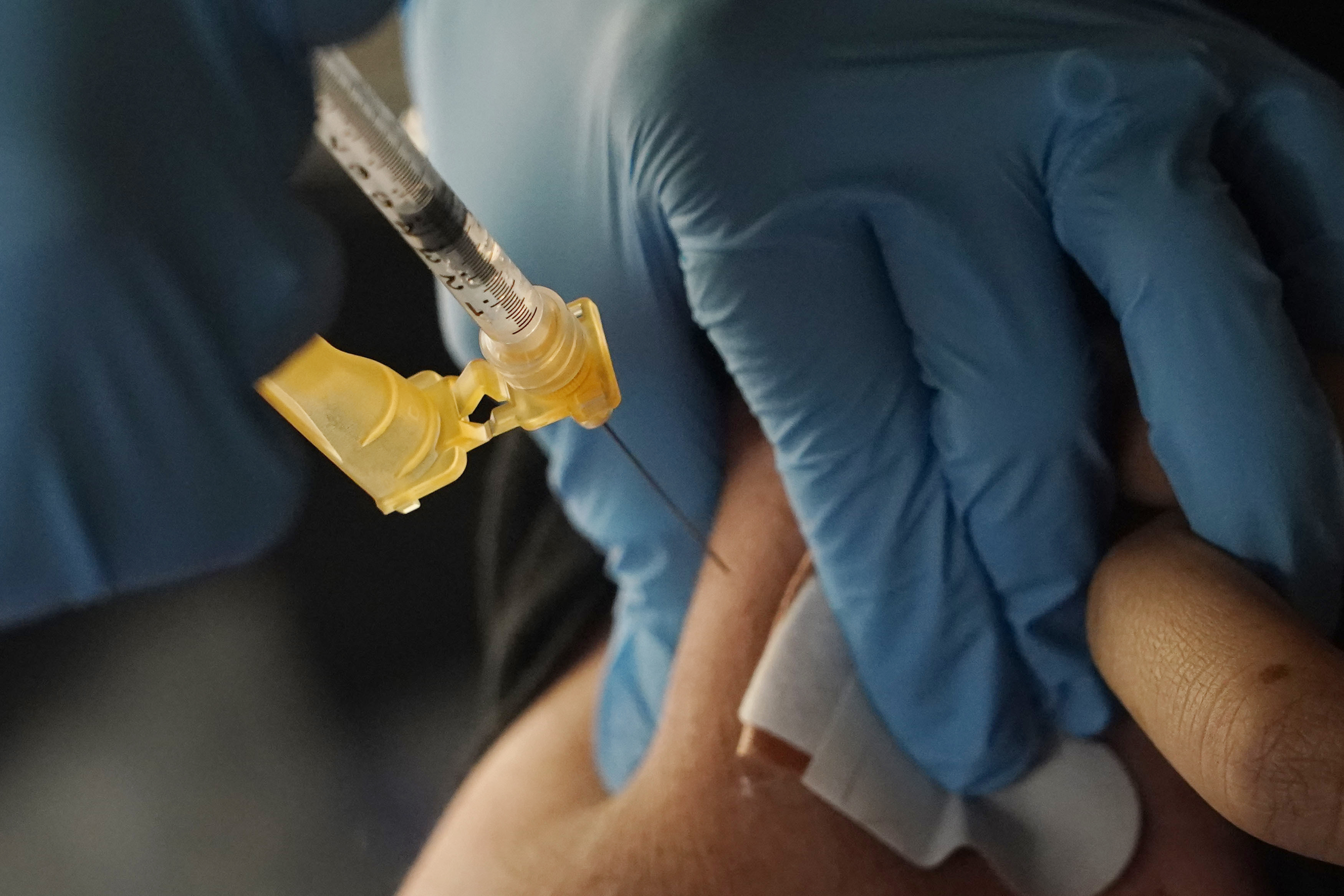 A nurse administers a Moderna COVID-19 booster vaccine at an inoculation station next to Jackson State University in Jackson, Miss., Friday, Nov. 18, 2022. U.S. regulators on Tuesday, April 18, 2023, cleared another COVID-19 booster dose for older adults and people with weak immune systems so they can shore up protection this spring — while taking steps to make coronavirus vaccinations simpler for everyone else.(AP Photo/Rogelio V. Solis)