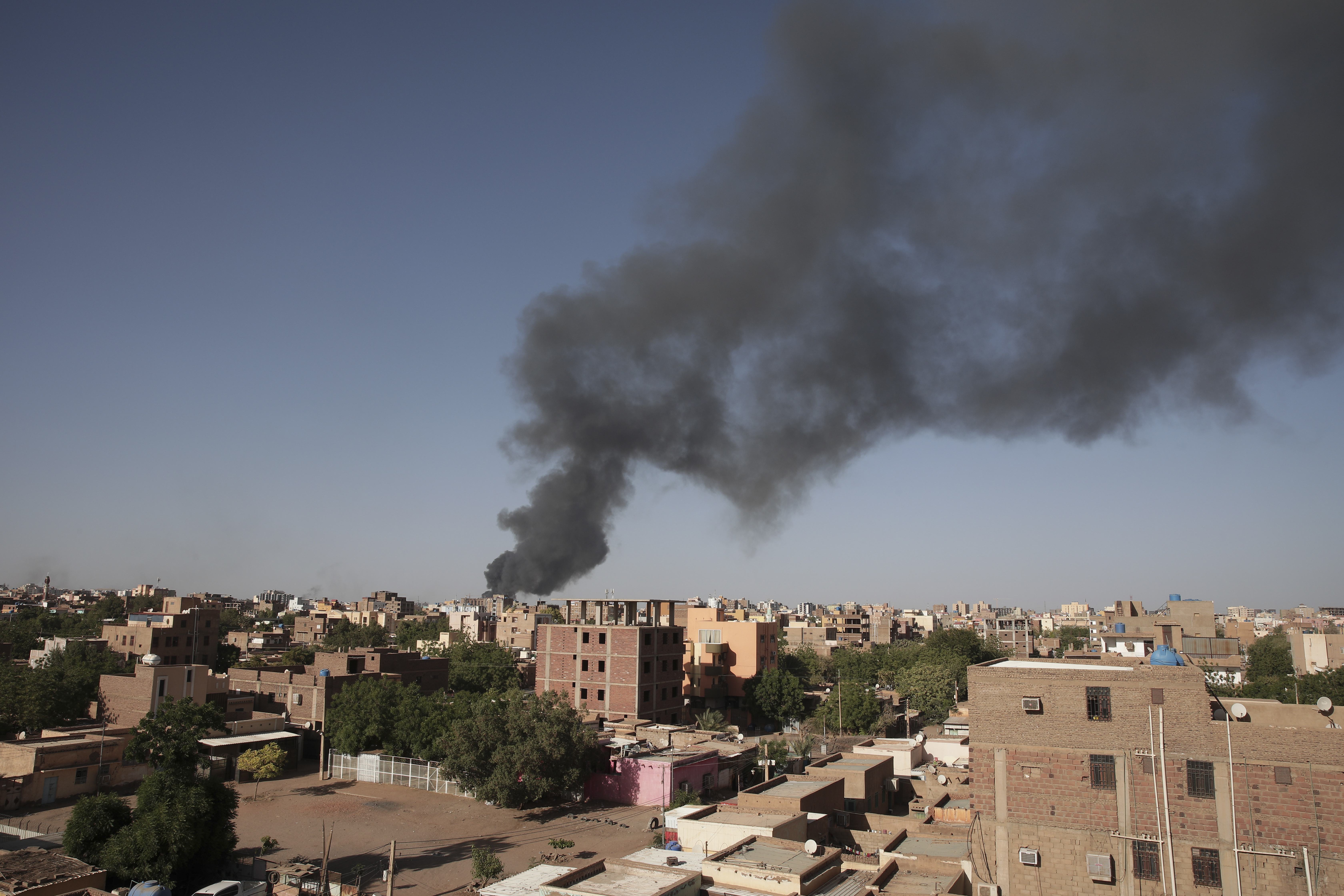 Smoke is seen in Khartoum, Sudan, Wednesday, April 19, 2023. Terrified Sudanese are fleeing their homes in the capital Khartoum, witnesses say, after an internationally brokered cease-fire failed and rival forces battled in the capital for a fifth day. (AP Photo/Marwan Ali)