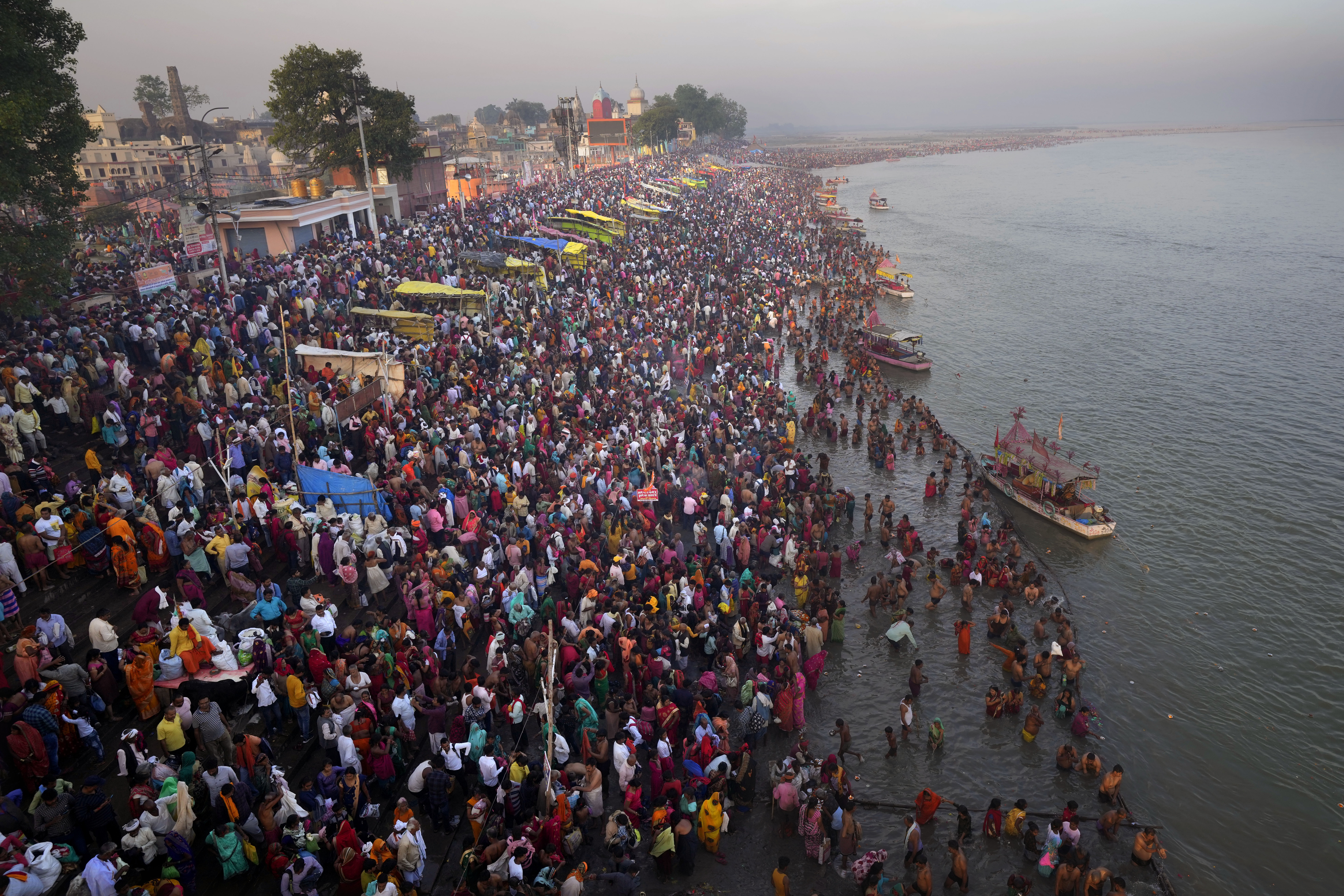 Thousands of Hindu devotees take a holy dip on the occasion of Ramnavi festival, celebrated as the birthday of Hindu God Rama, in Ayodhya, India, Thursday, March 30, 2023. India is on track to become the world's most populous nation, surpassing China by 2.9 million people by mid-2023, according to data released by the United Nations on Wednesday. The South Asian country will have an estimated 1.4286 billion people against China's 1.4257 billion by the middle of the year, according to U.N. projections.(AP Photo/Manish Swarup)