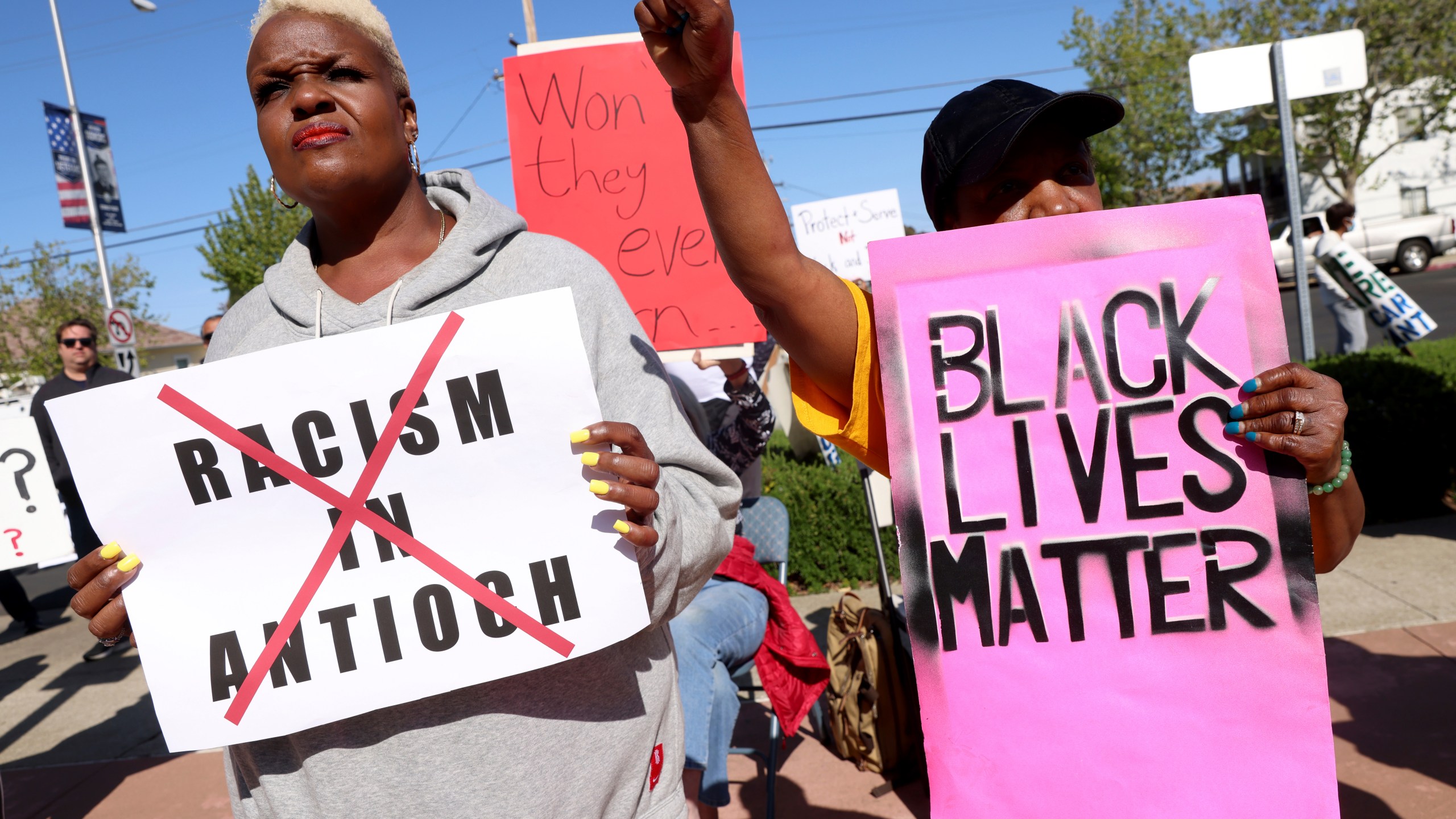 Kiora Hansen and Della Currie, from left, protest during a rally at Antioch police headquarters in Antioch, Calif., on Tuesday, April 18, 2023. The city council of a small San Francisco Bay Area city voted Tuesday to launch three audits of its troubled Antioch Police Department, the latest development in a year-long federal investigation of the police force that blew up this month with the disclosure of racist text messages among officers. (Jane Tyska/Bay Area News Group via AP)