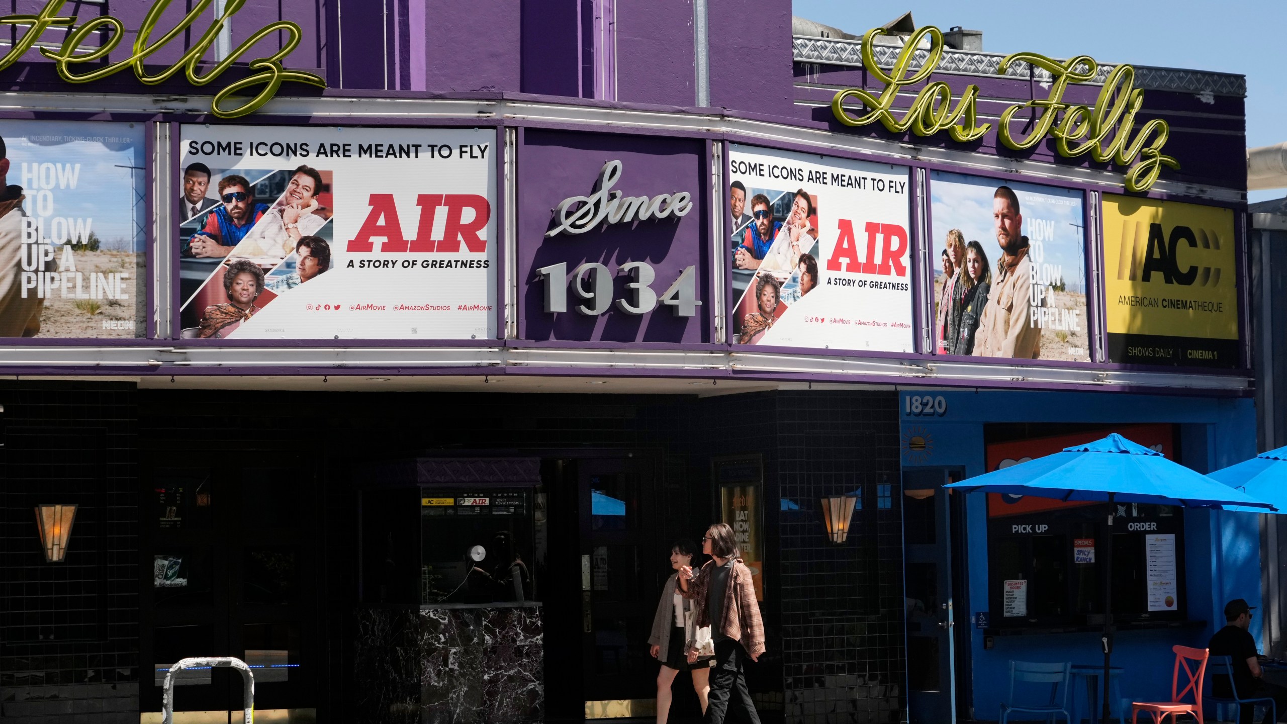 Poster art for the Amazon Studios film "Air" is displayed on the marquee of the Los Feliz Theater, Wednesday, April 19, 2023, in Los Angeles. Amazon Studios plans to release 12 to 15 movies theatrically every year, and Apple is set to spend $1 billion a year on movies that will land in cinemas before streaming. (AP Photo/Chris Pizzello)