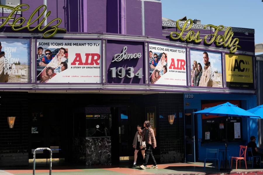 Poster art for the Amazon Studios film "Air" is displayed on the marquee of the Los Feliz Theater, Wednesday, April 19, 2023, in Los Angeles. Amazon Studios plans to release 12 to 15 movies theatrically every year, and Apple is set to spend $1 billion a year on movies that will land in cinemas before streaming. (AP Photo/Chris Pizzello)