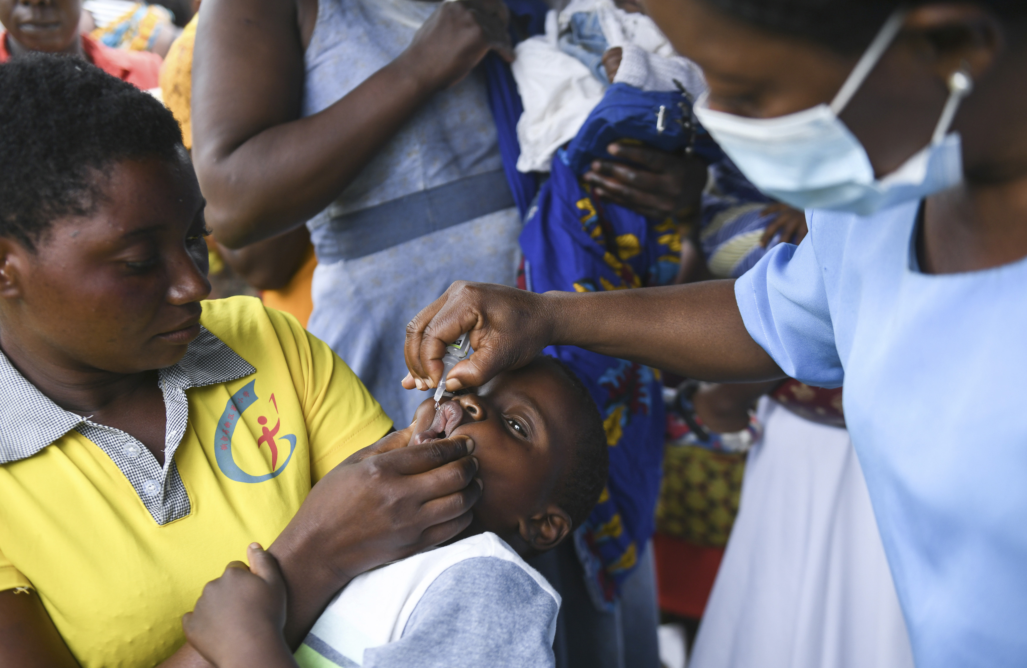 FILE— A child receives a polio vaccine, during the Malawi Polio Vaccination Campaign Launch in Lilongwe Malawi, Sunday March 20, 2022. A new report from UNICEF says nearly 13 million children missed one or more vaccinations in Africa between 2019 and 2021 because of the disruptive impact of the COVID-19 pandemic, (AP Photo/Thoko Chikondi/File)