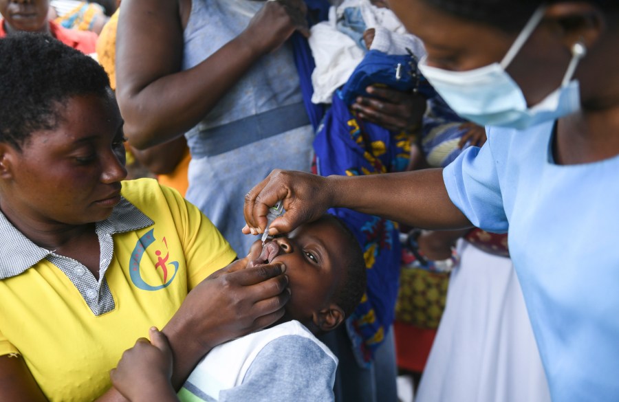 FILE— A child receives a polio vaccine, during the Malawi Polio Vaccination Campaign Launch in Lilongwe Malawi, Sunday March 20, 2022. A new report from UNICEF says nearly 13 million children missed one or more vaccinations in Africa between 2019 and 2021 because of the disruptive impact of the COVID-19 pandemic, (AP Photo/Thoko Chikondi/File)