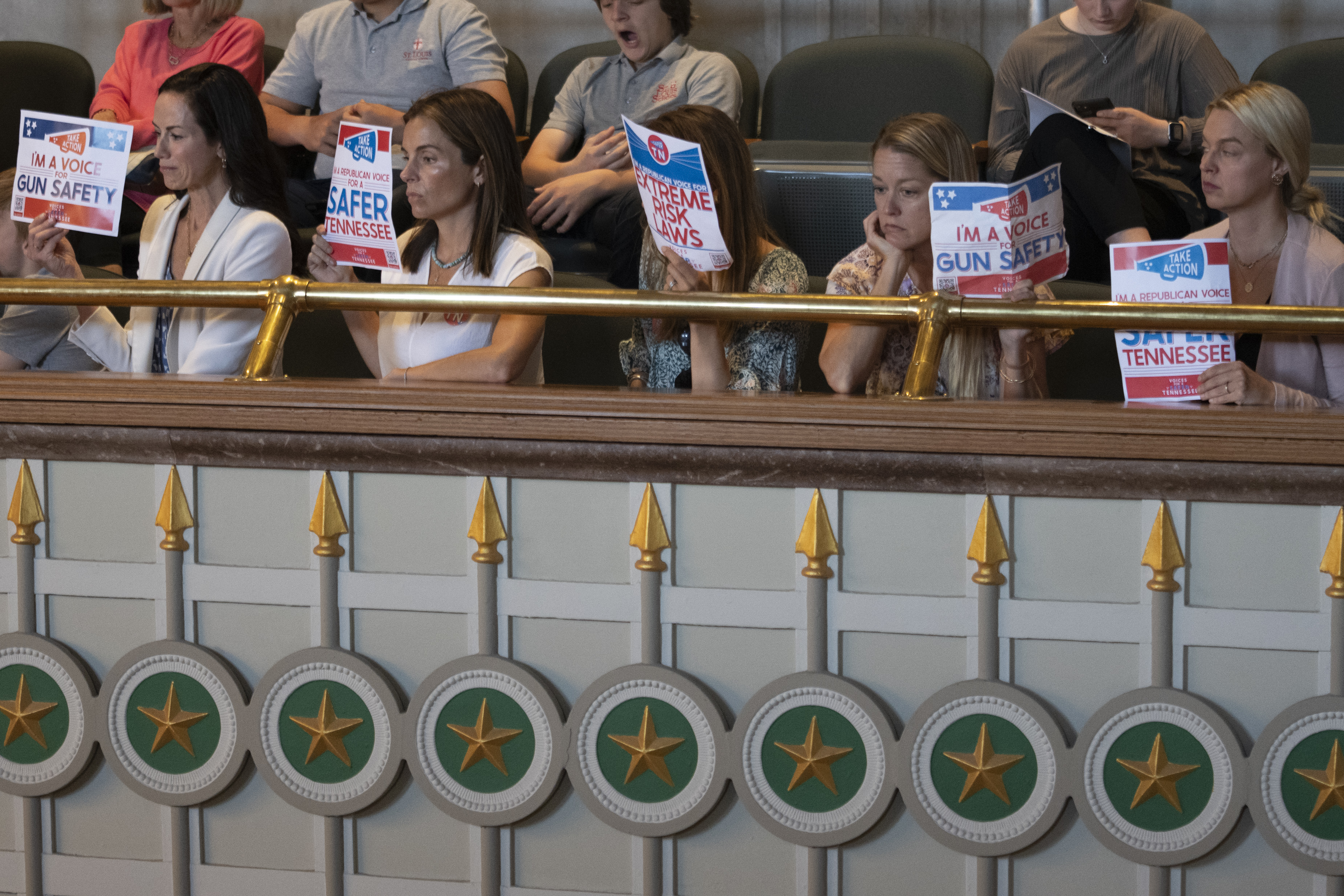 Members of Voices for a Safer Tennessee hold signs as they attend a Senate legislative session at the state Capitol, Thursday, April 20, 2023 in Nashville, Tenn. The group is advocating for gun-control laws following the Covenant School Shooting that happened March 27. (AP Photo/George Walker IV)