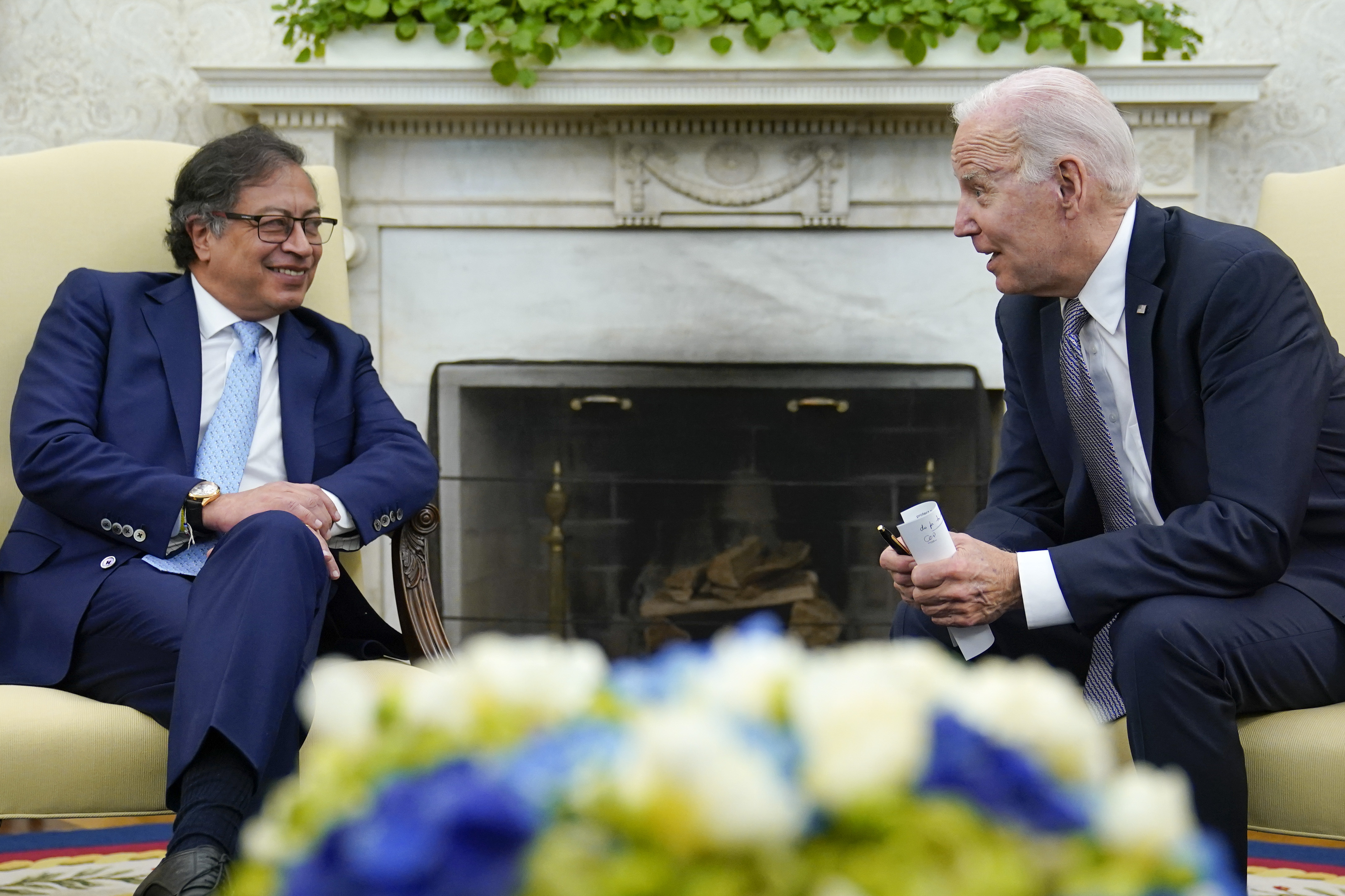 President Joe Biden leans over to speak with Colombian President Gustavo Petro as reporters yell questions after they gave statements in the Oval Office of the White House in Washington, Thursday, April 20, 2023. (AP Photo/Susan Walsh)