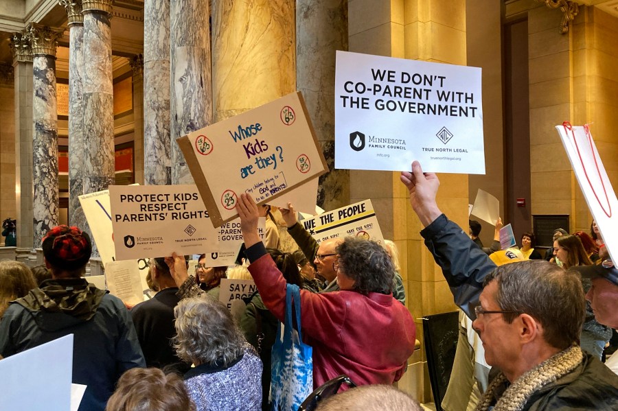 Opponents and supporters gather outside the Senate chamber in the Minnesota State Capitol, Friday, April 21, 2023, in St. Paul, Minn., ahead of votes on bills to make Minnesota a refuge for youth seeking gender-affirming care, to protect abortion patients from other states, and to ban so-called conversion therapy for LGBTQ+ youth. (AP Photo/Steve Karnowski)