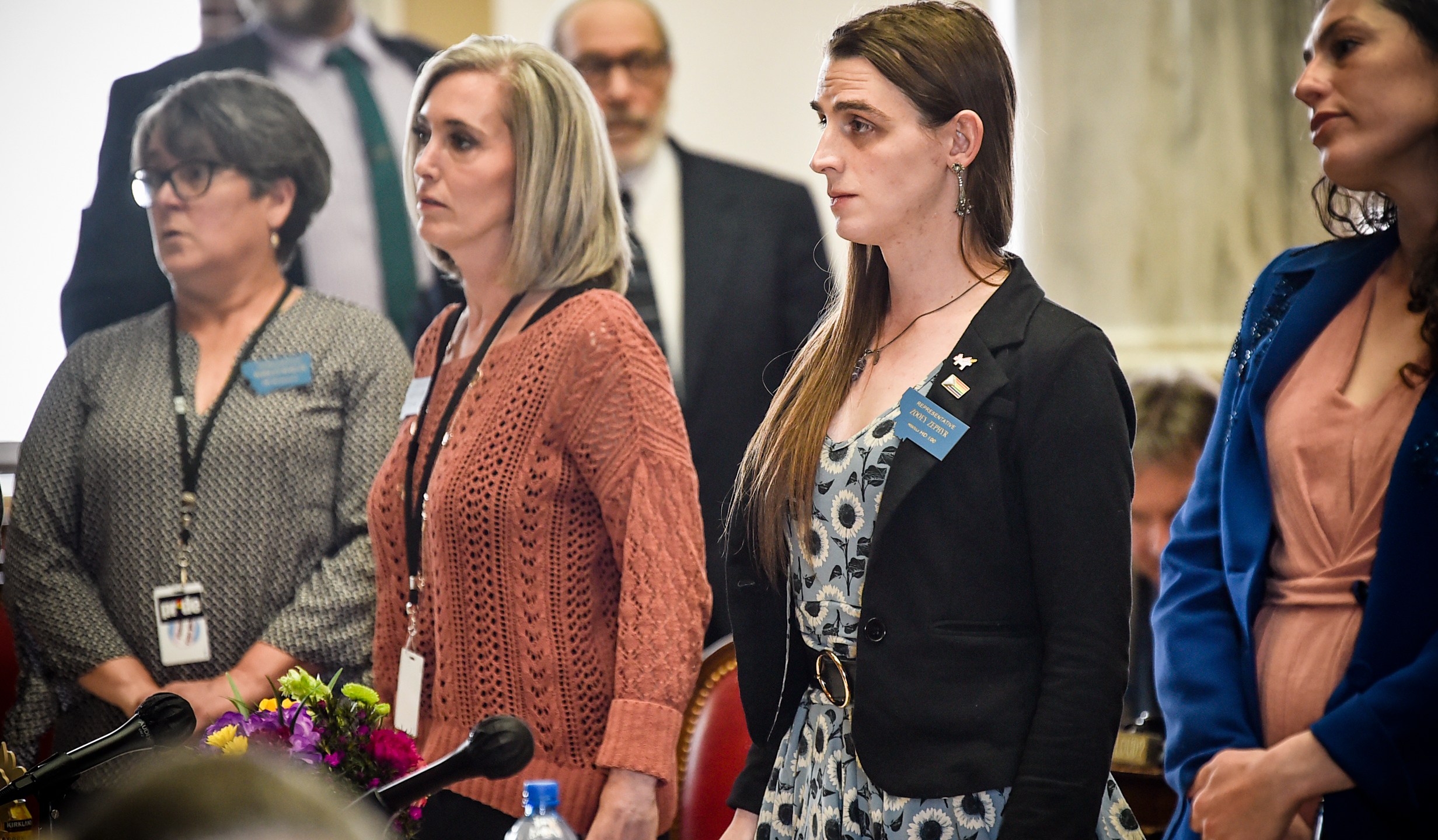 Rep. Zoey Zephyr, D-Missoula, second from right, stands with members of the minority party on the house floor on Thursday, April 20, 2023 at the state capitol in Helena, Mont. (Thom Bridge/Independent Record via AP)